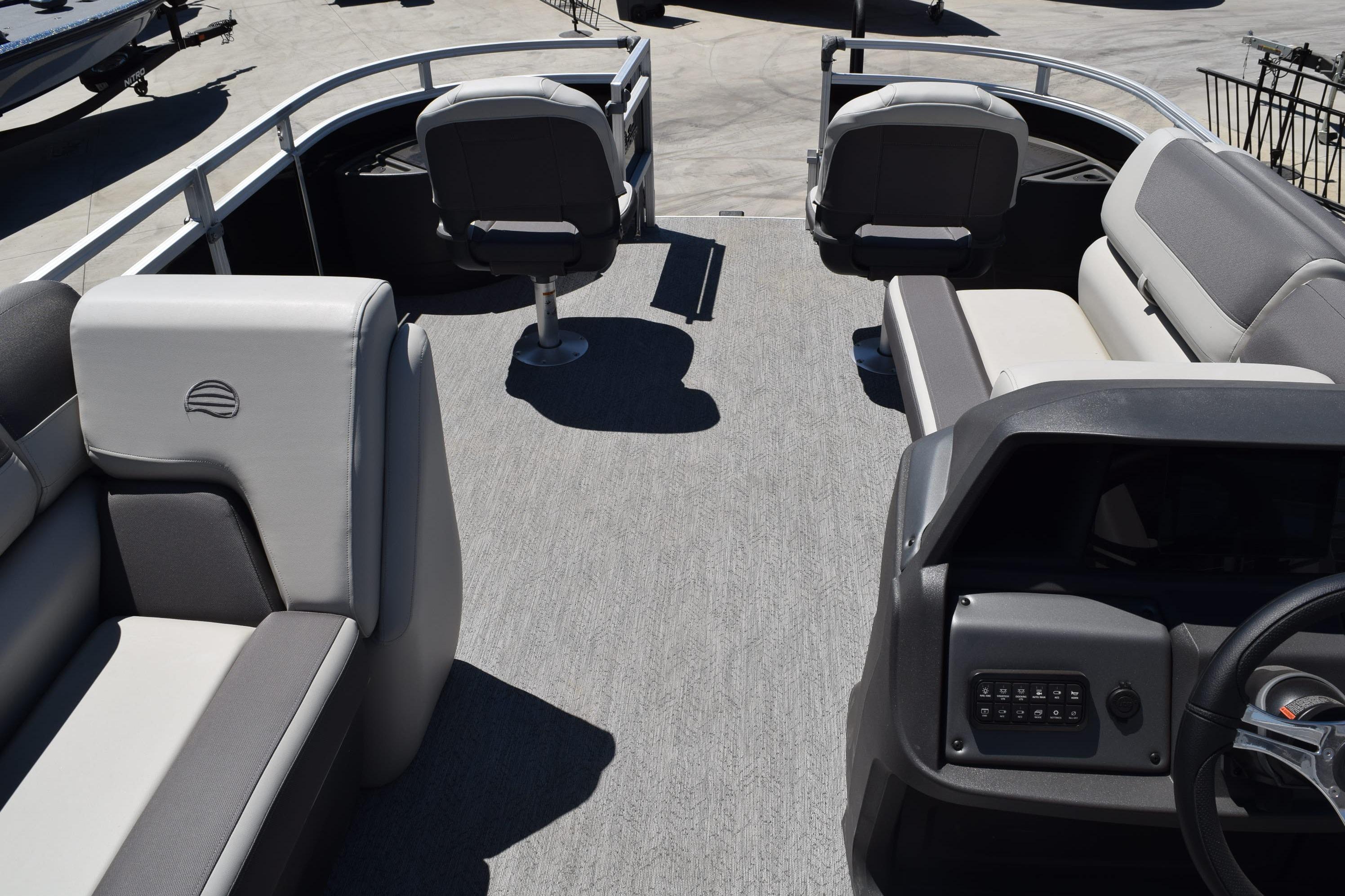 2026 Sun Tracker Fishin' Barge 20 DLX interior with seating and control panel.
