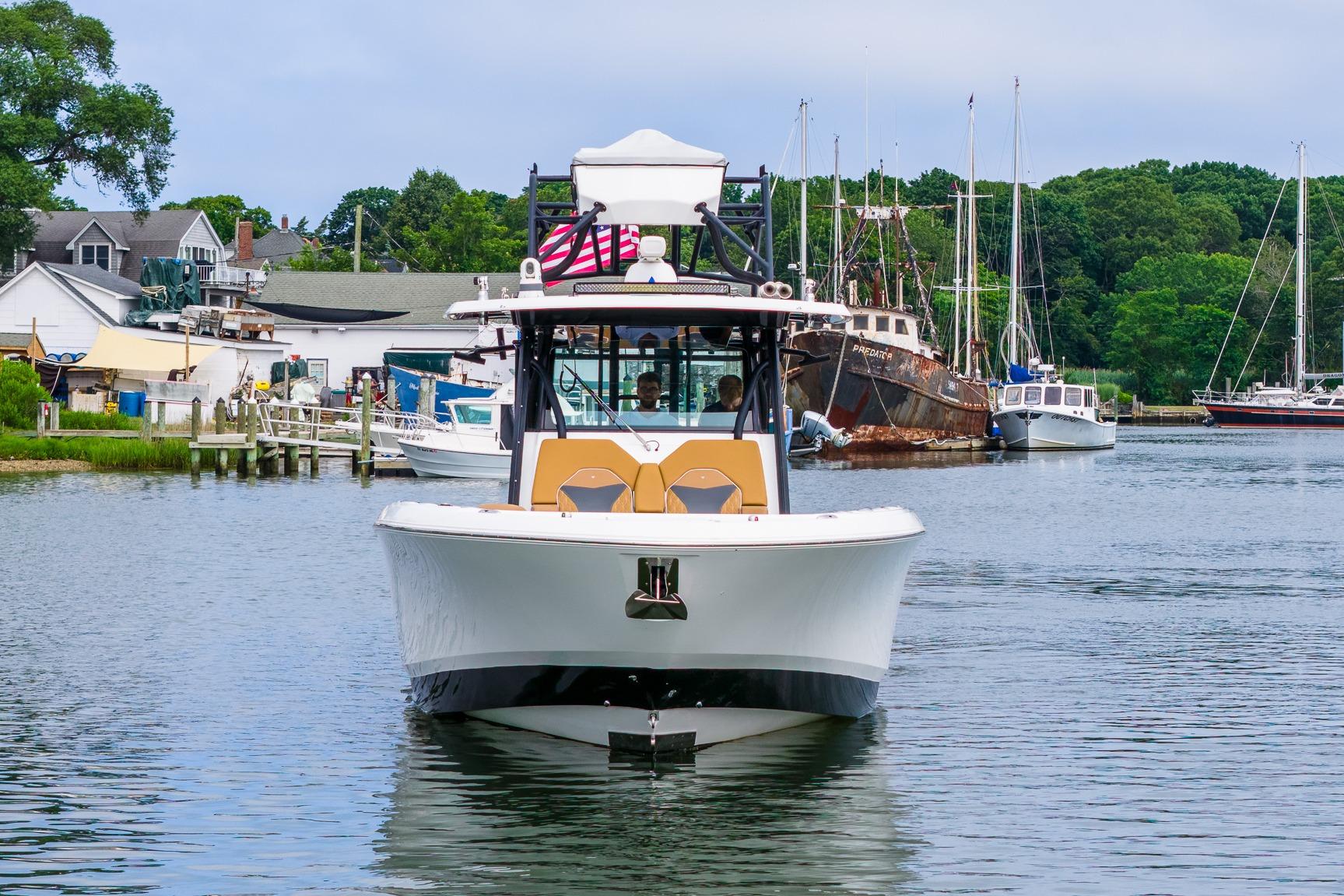 2021 Wellcraft 402 Fisherman boat docked in a scenic marina setting.