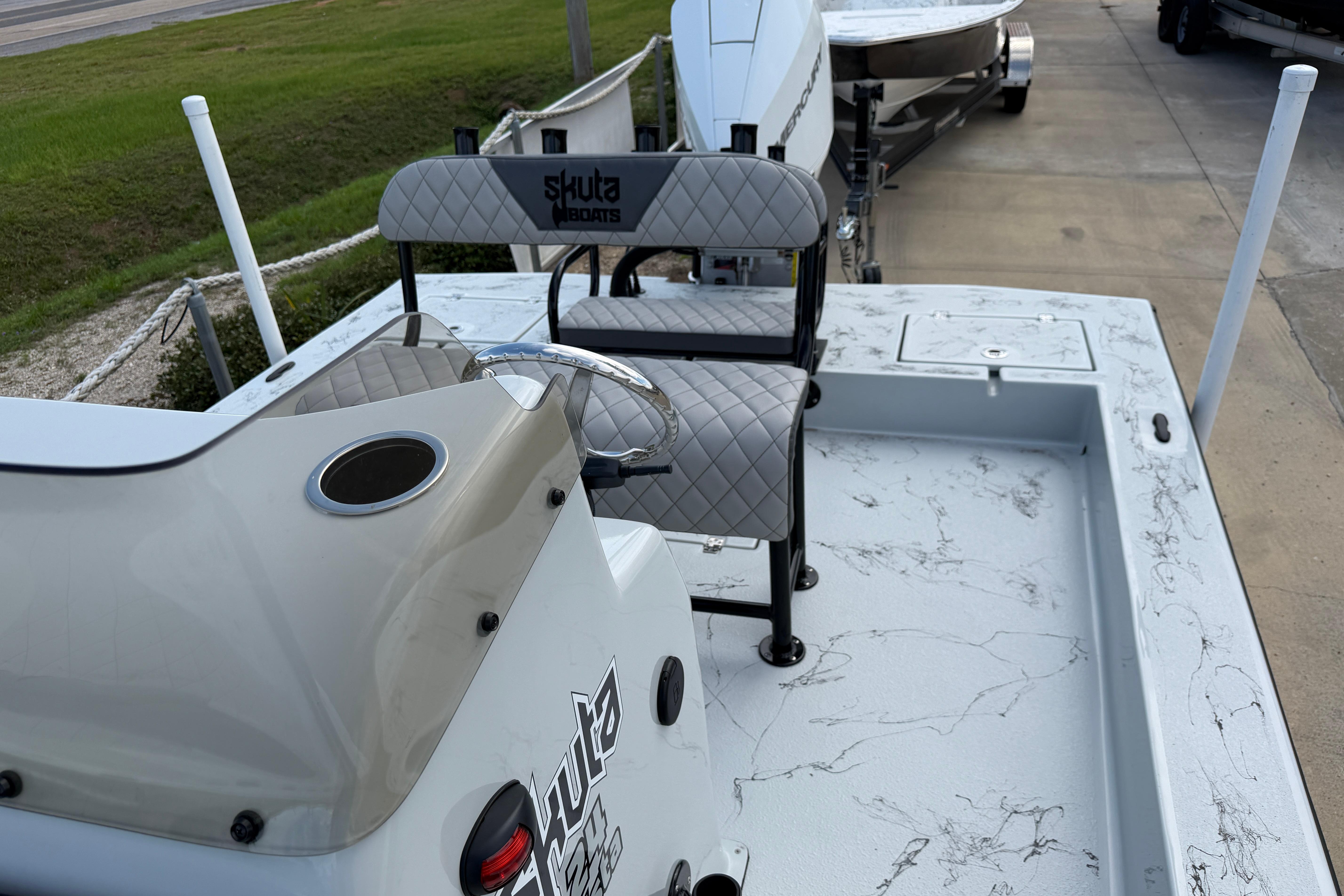 2026 Skuta Vista 24 boat interior with quilted seats and steering console.
