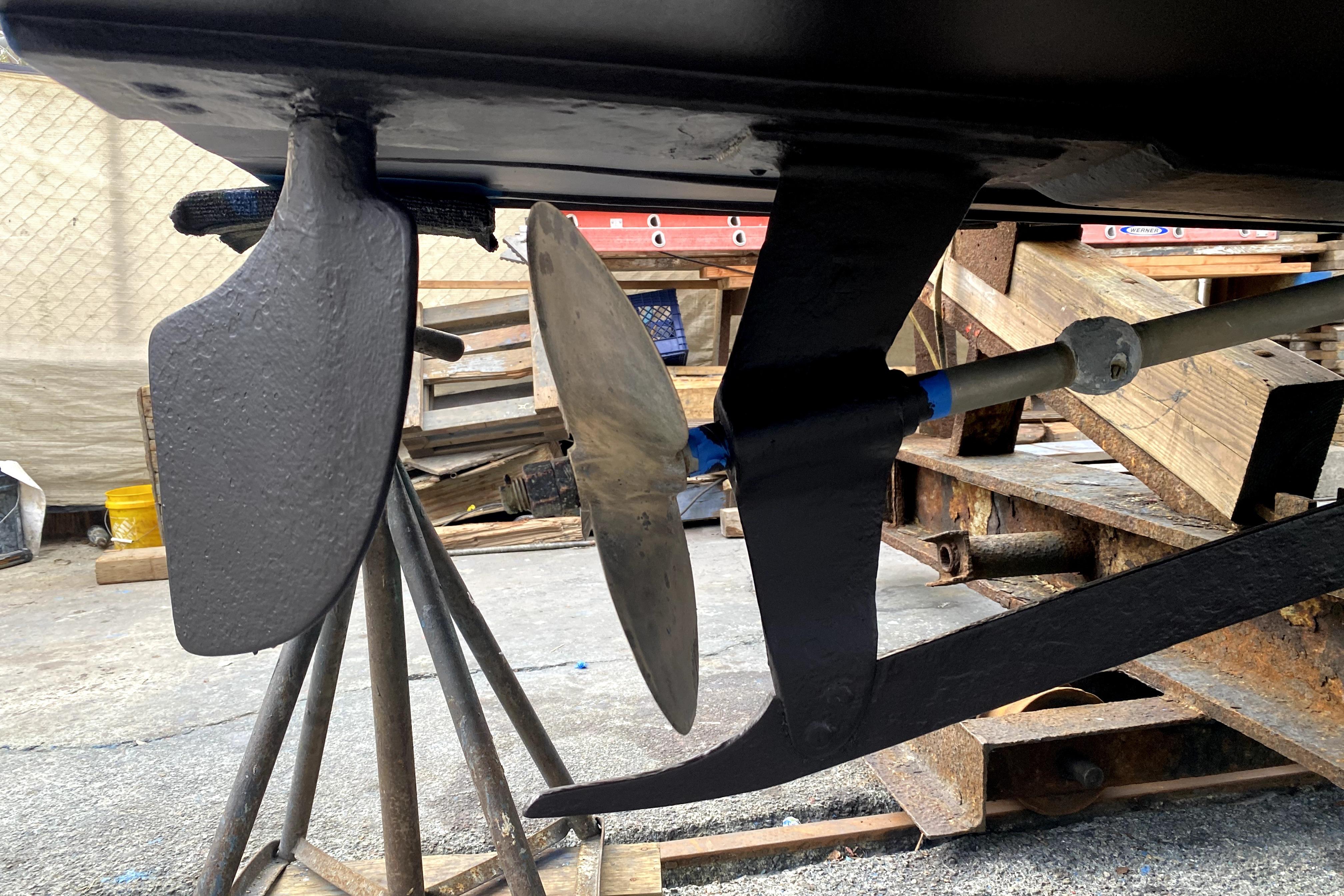1964 Lyman 25 Sleeper boat propeller and rudder on dry dock.
