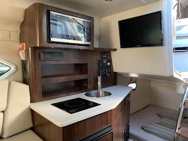 Interior of the 2017 Regal 26 Express with kitchenette and TV.
