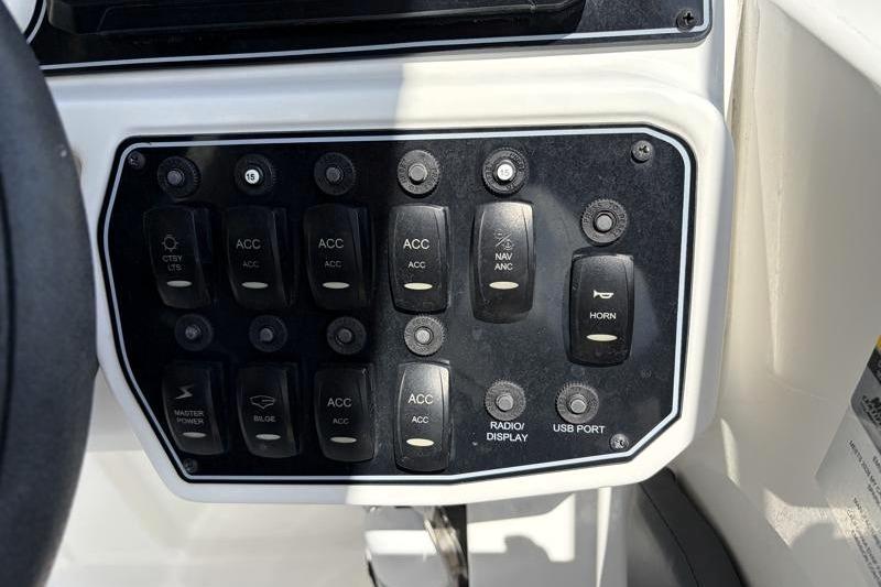 Control panel of 2026 Hurricane SunDeck Sport 2050 OB boat with various switches and buttons.