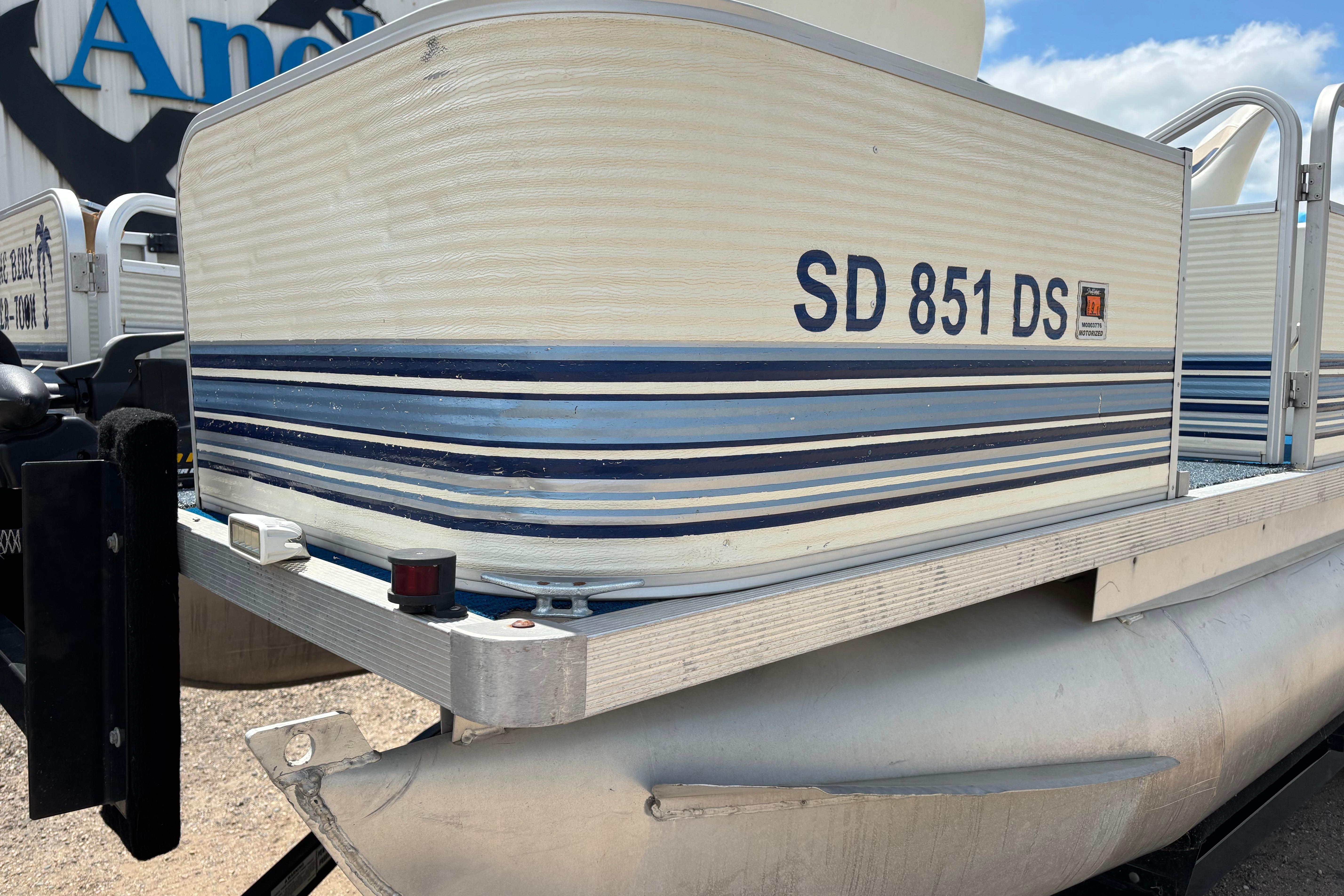 1997 Northwood 24' Pontoon boat with registration SD 851 DS, featuring blue and white stripes.
