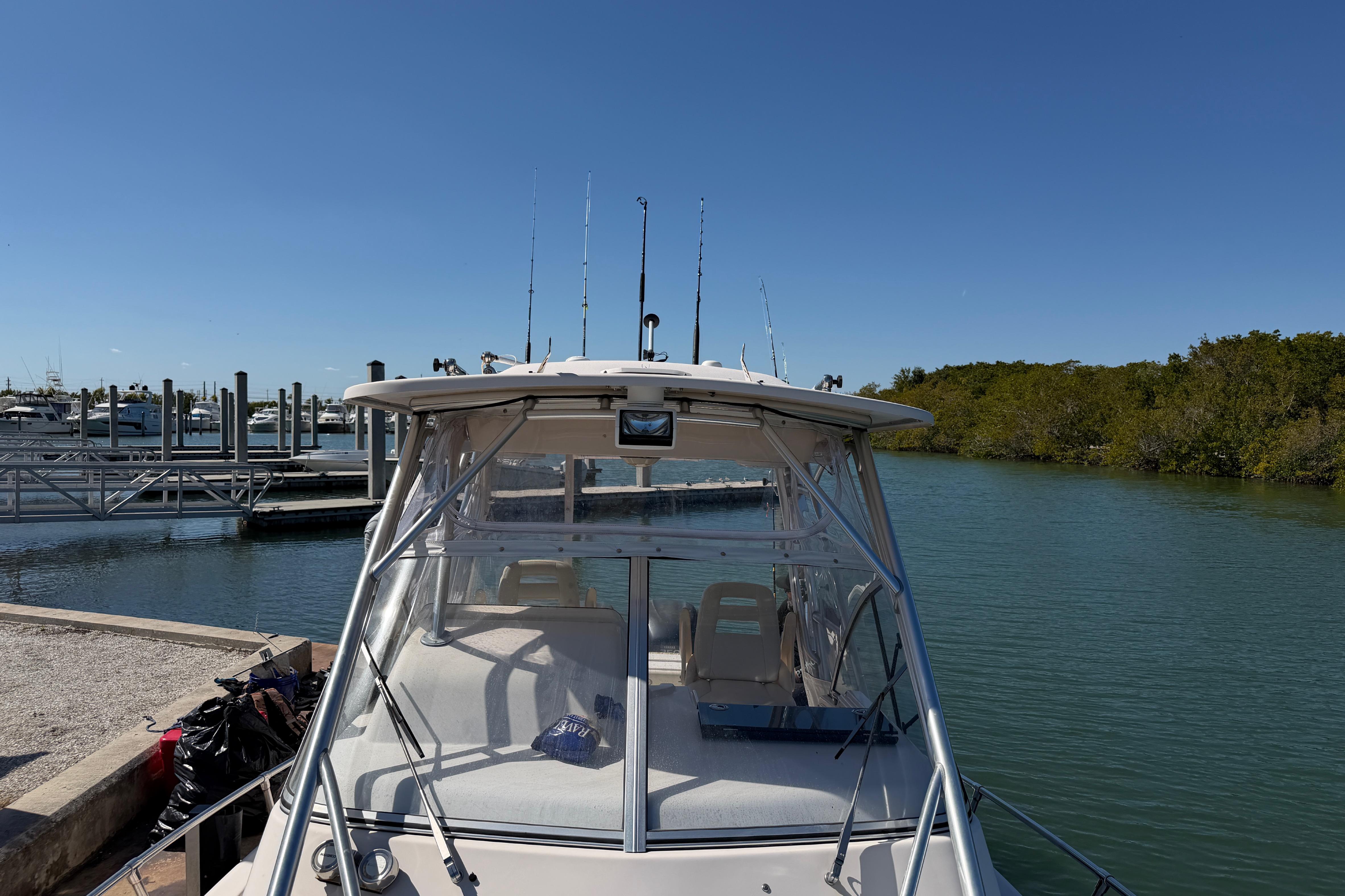 2006 Grady-White Sailfish 282 boat docked by a marina under clear blue skies.