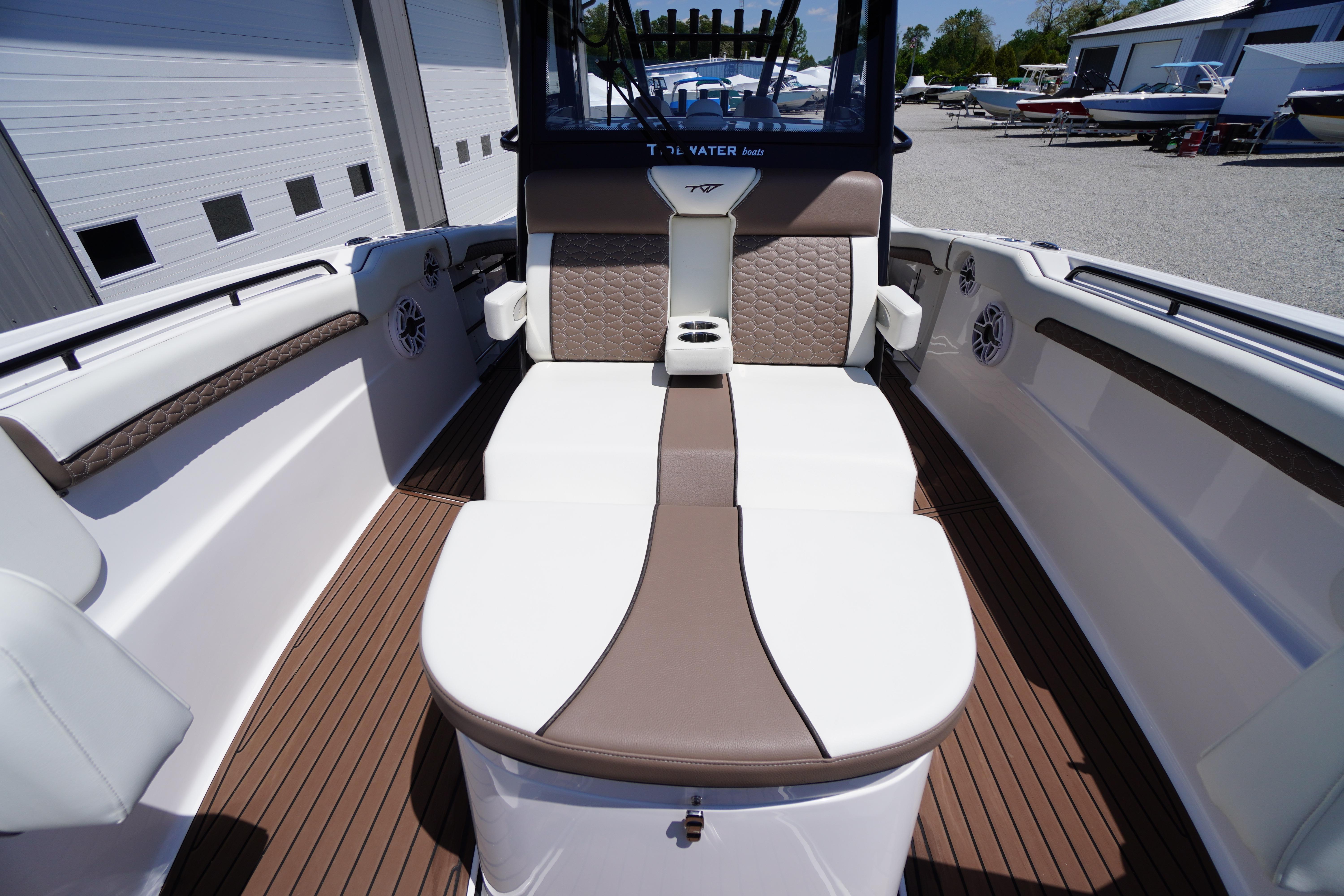 2024 Tidewater 320 CC Adventure boat interior with cushioned seating and cup holders.