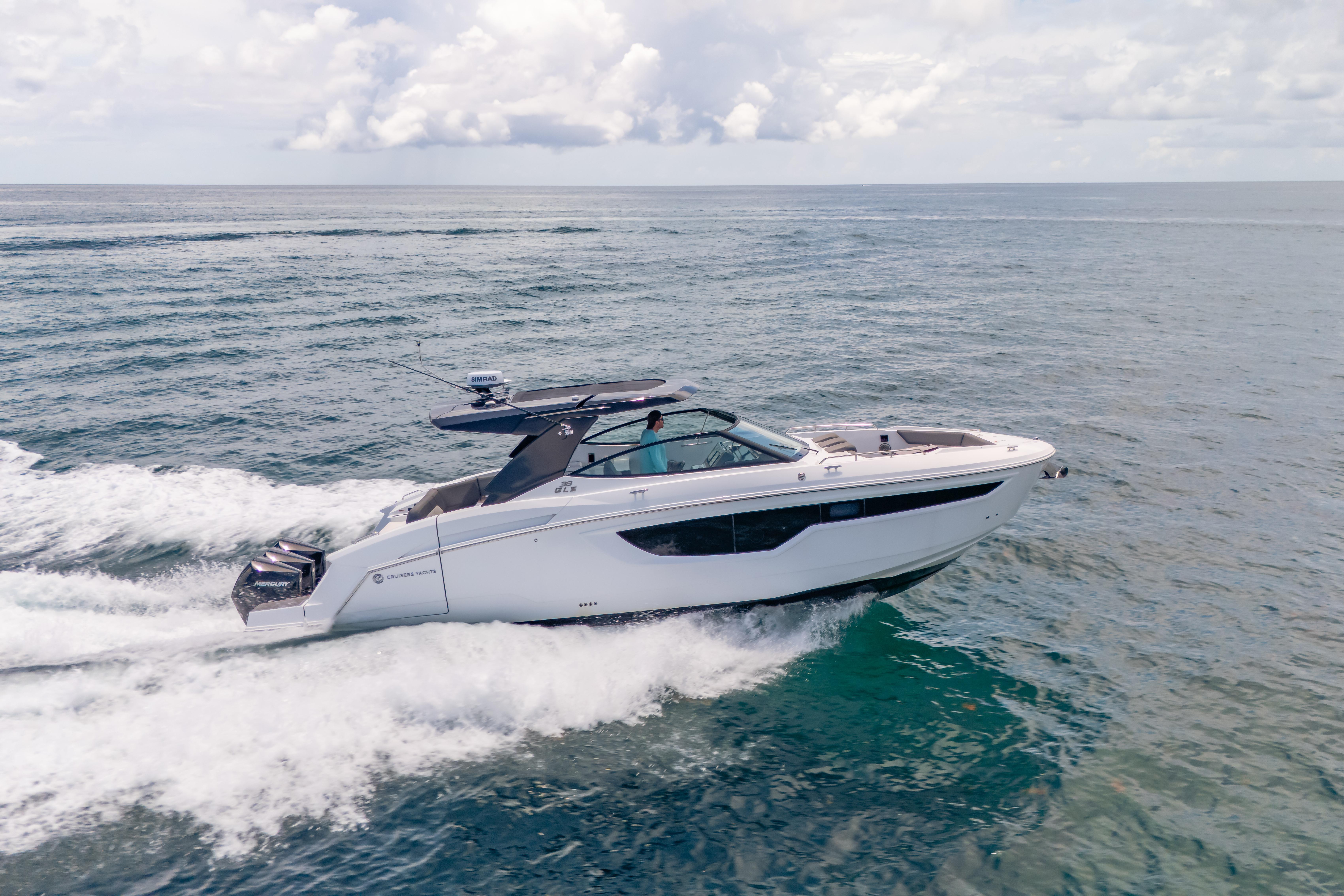 2021 Cruisers Yachts 38 GLS speeding on open water under a cloudy sky.