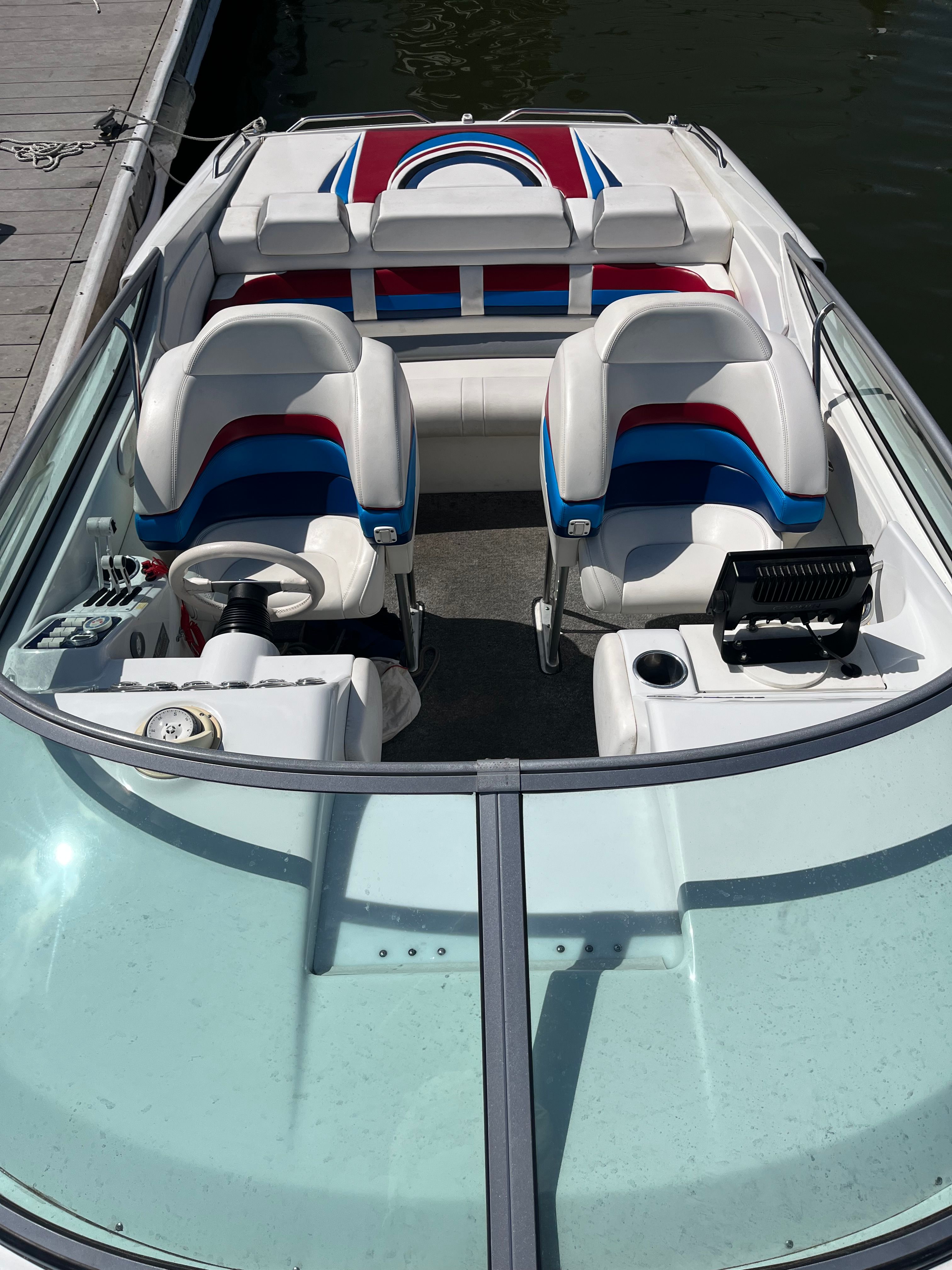 The image shows the cockpit of a 2004 Formula 292 FASTech boat with colorful seats.