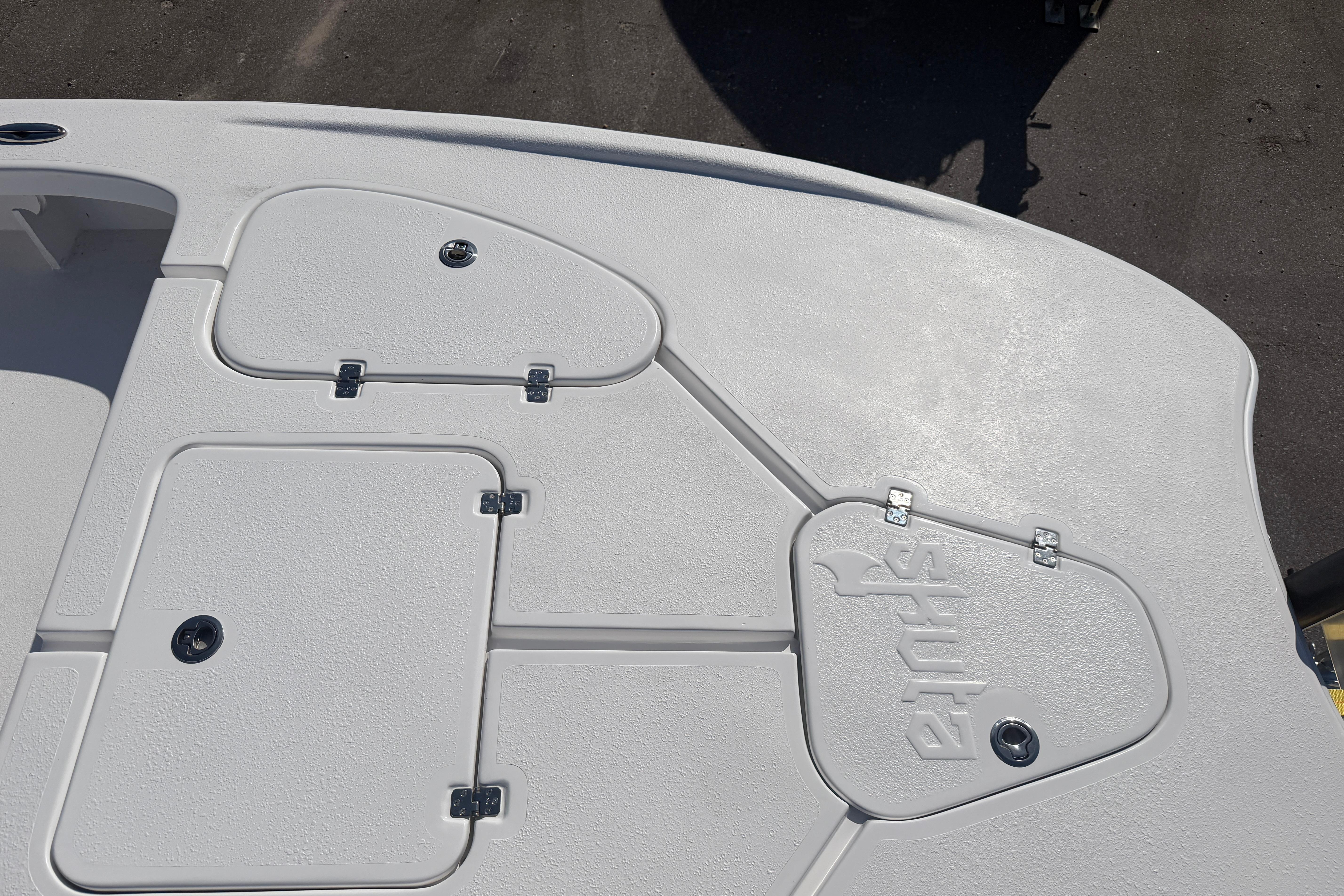 Deck view of 2026 Skuta 24 Cat boat with storage compartments and textured surface.