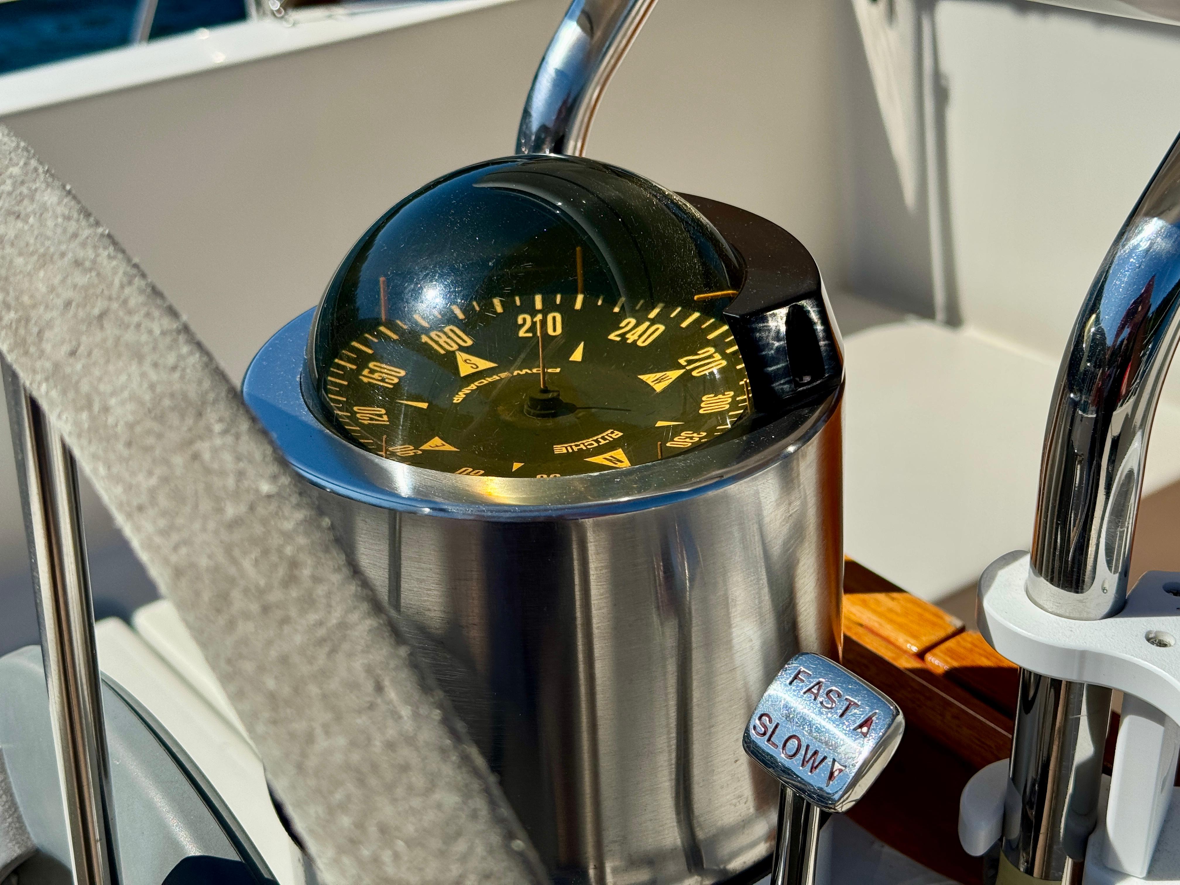 Compass and throttle controls on a 1989 Nonsuch 30 Ultra sailboat.