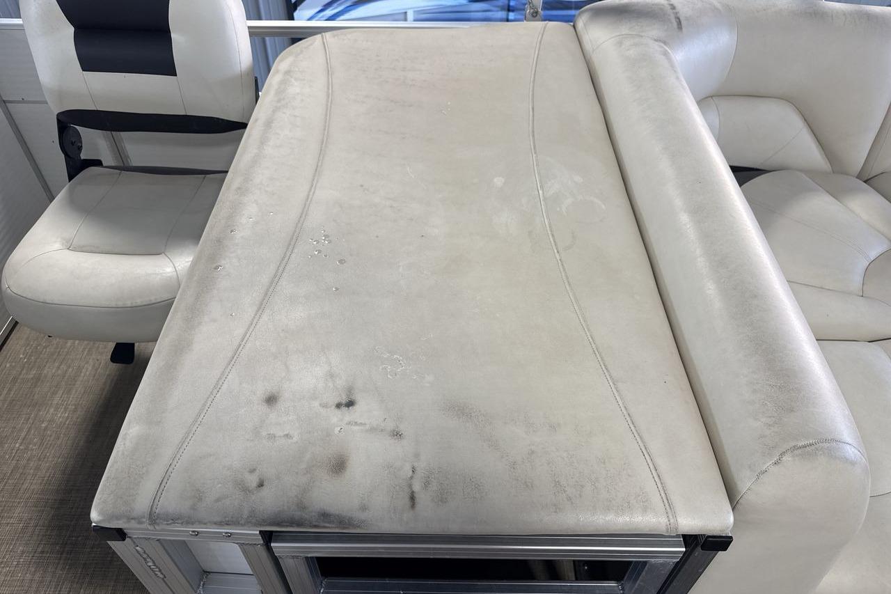 2018 Landau Alure 212 Fish boat interior with worn beige upholstery and seating.