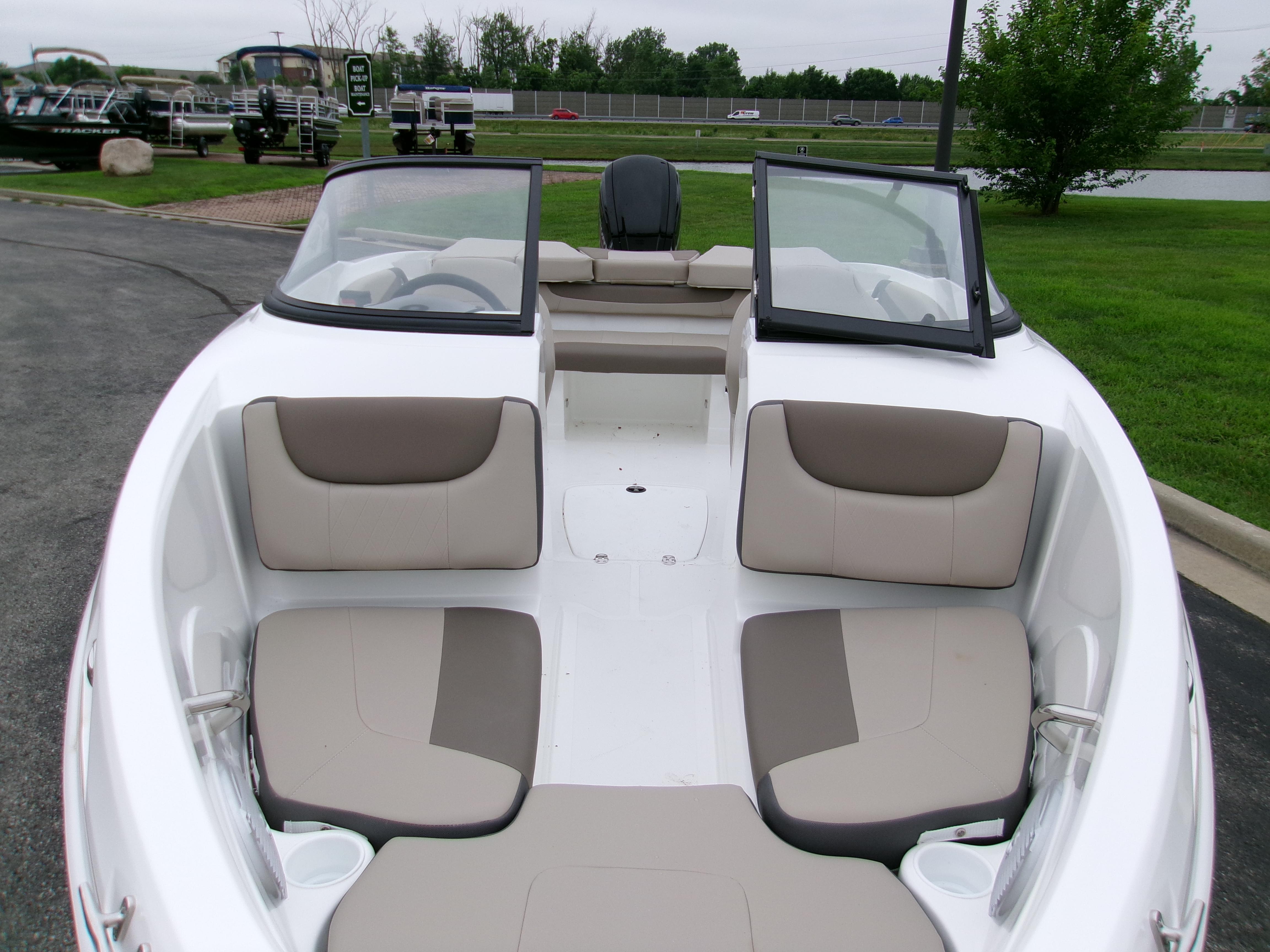 2025 Tahoe 200 S boat interior with beige seating, open windshield, and cup holders.