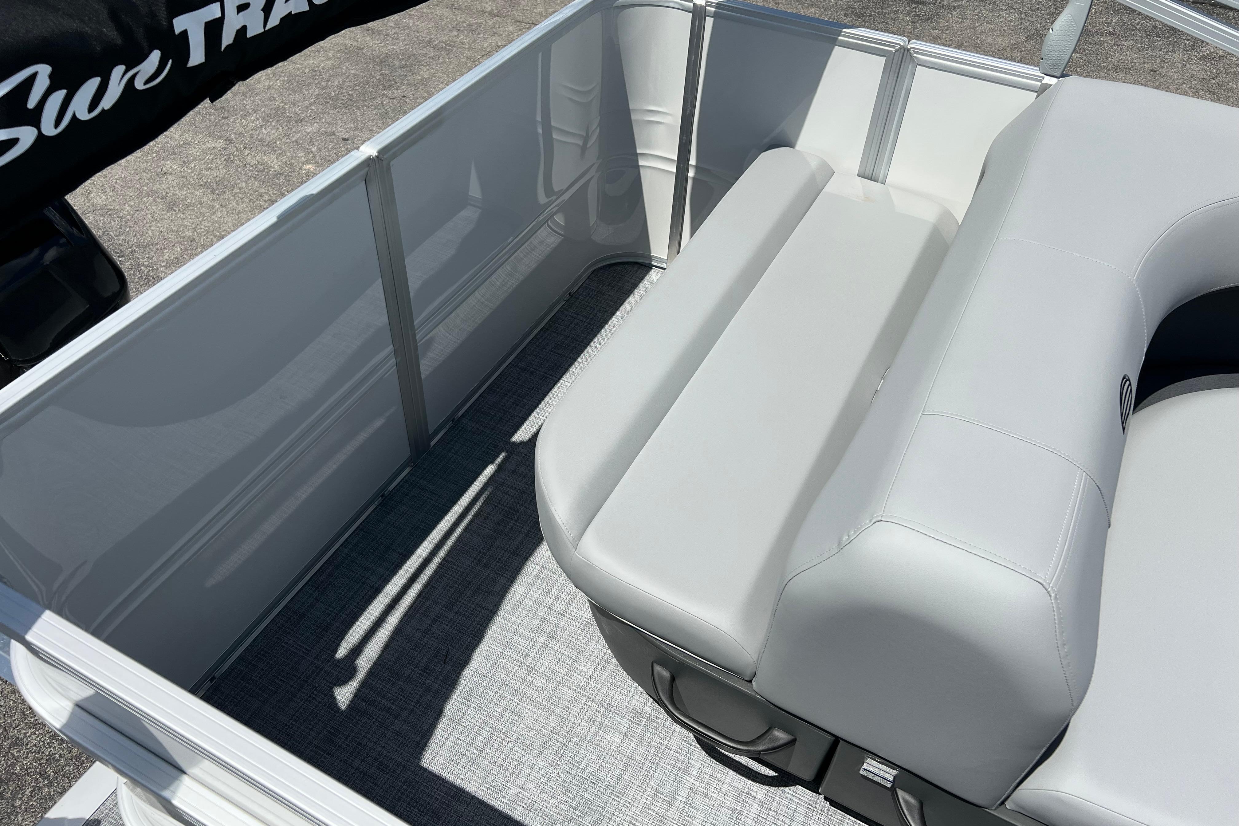 2026 Sun Tracker Party Barge 18 DLX interior with gray seating and flooring.