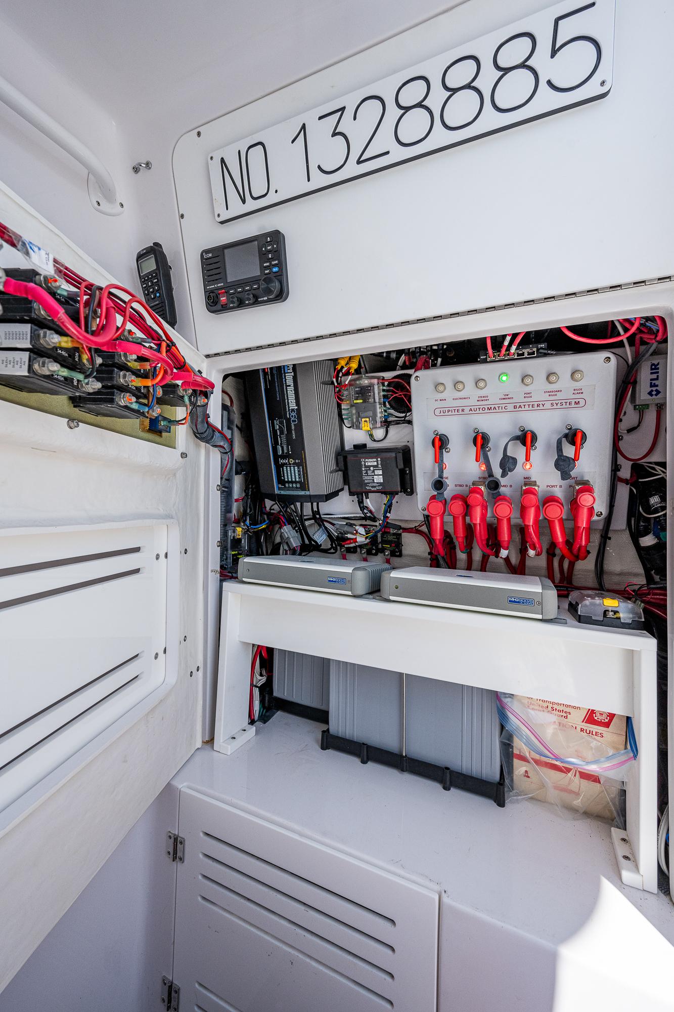 Electrical panel inside 2023 Jupiter 38 boat, showcasing wiring and control systems.