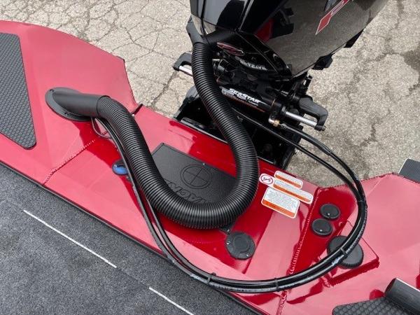 2025 Tracker Savage 215 boat engine area with red detailing and black tubing.
