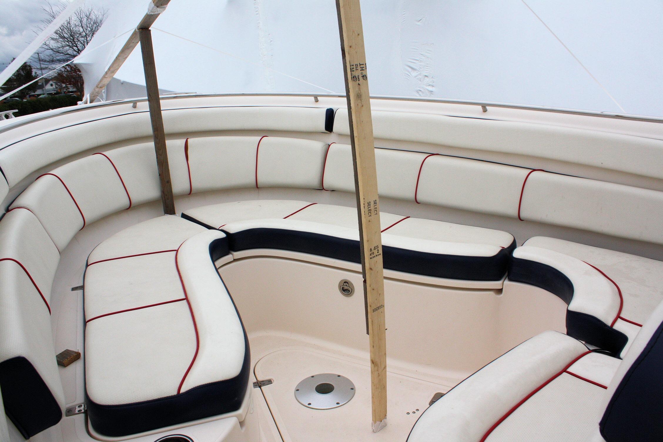 2013 Pursuit ST 310 Sport boat interior with white and red cushioned seating.