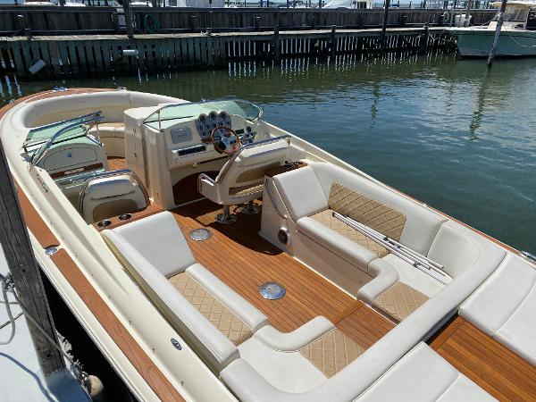 2014 Chris-Craft Launch 28 boat with elegant interior and wooden deck, docked at marina.