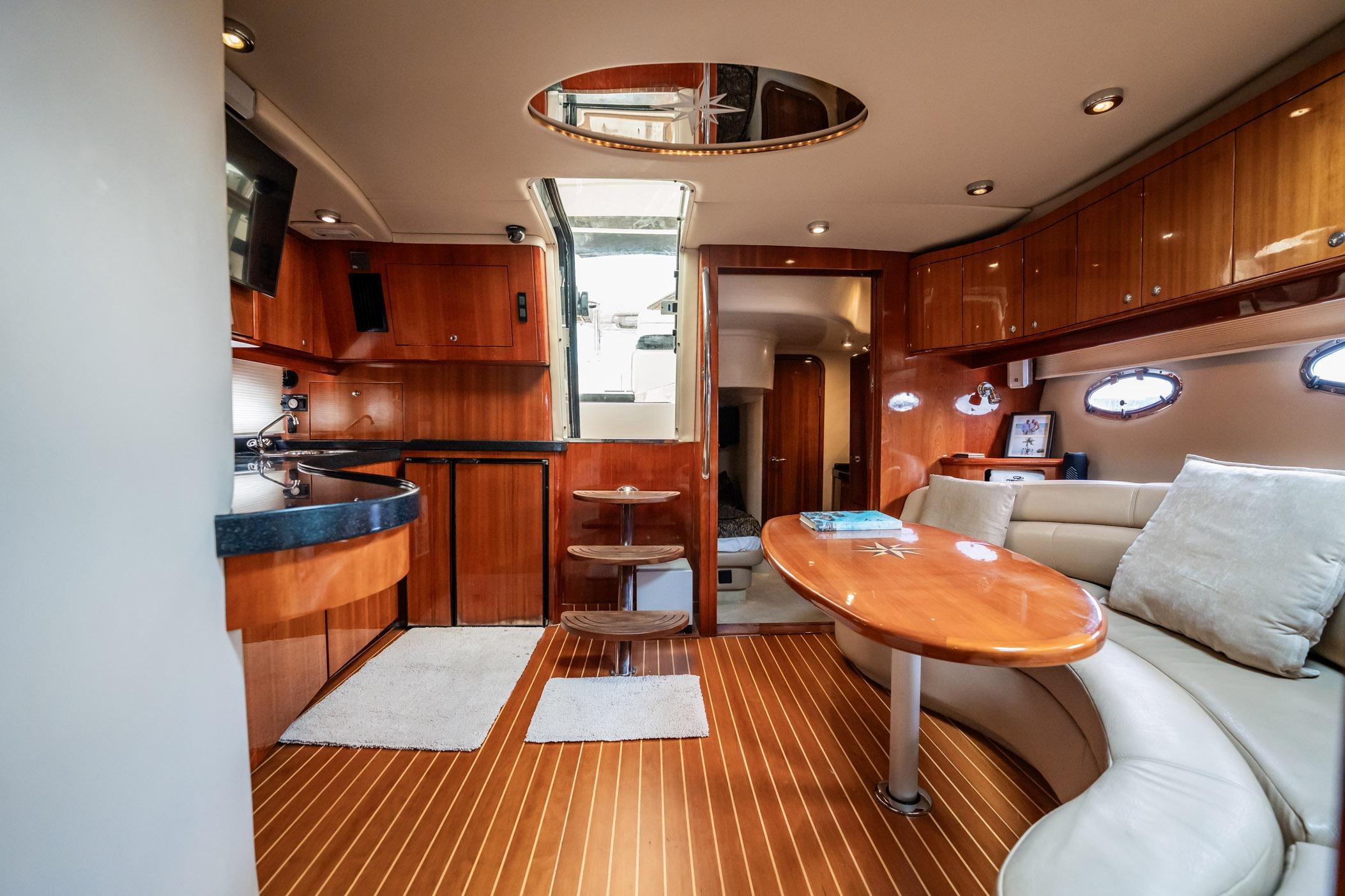 Luxurious interior of 2008 Regal Commodore 4460 yacht with wood finishes and modern amenities.
