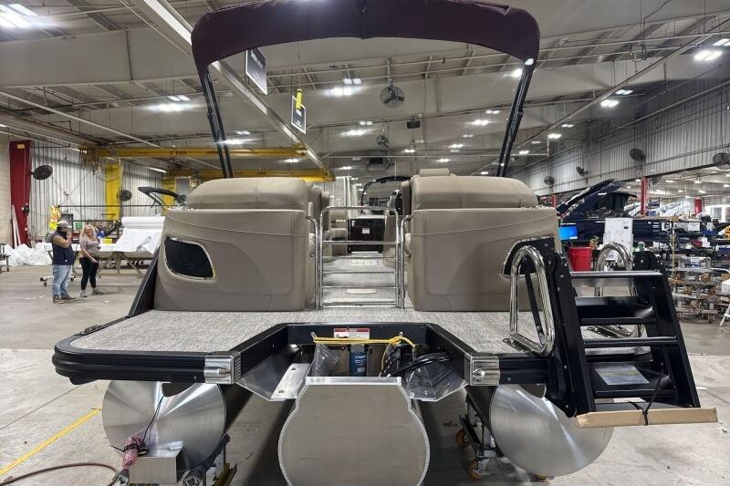 2026 Bennington 24 LXS Quadbench pontoon boat in a spacious indoor facility.