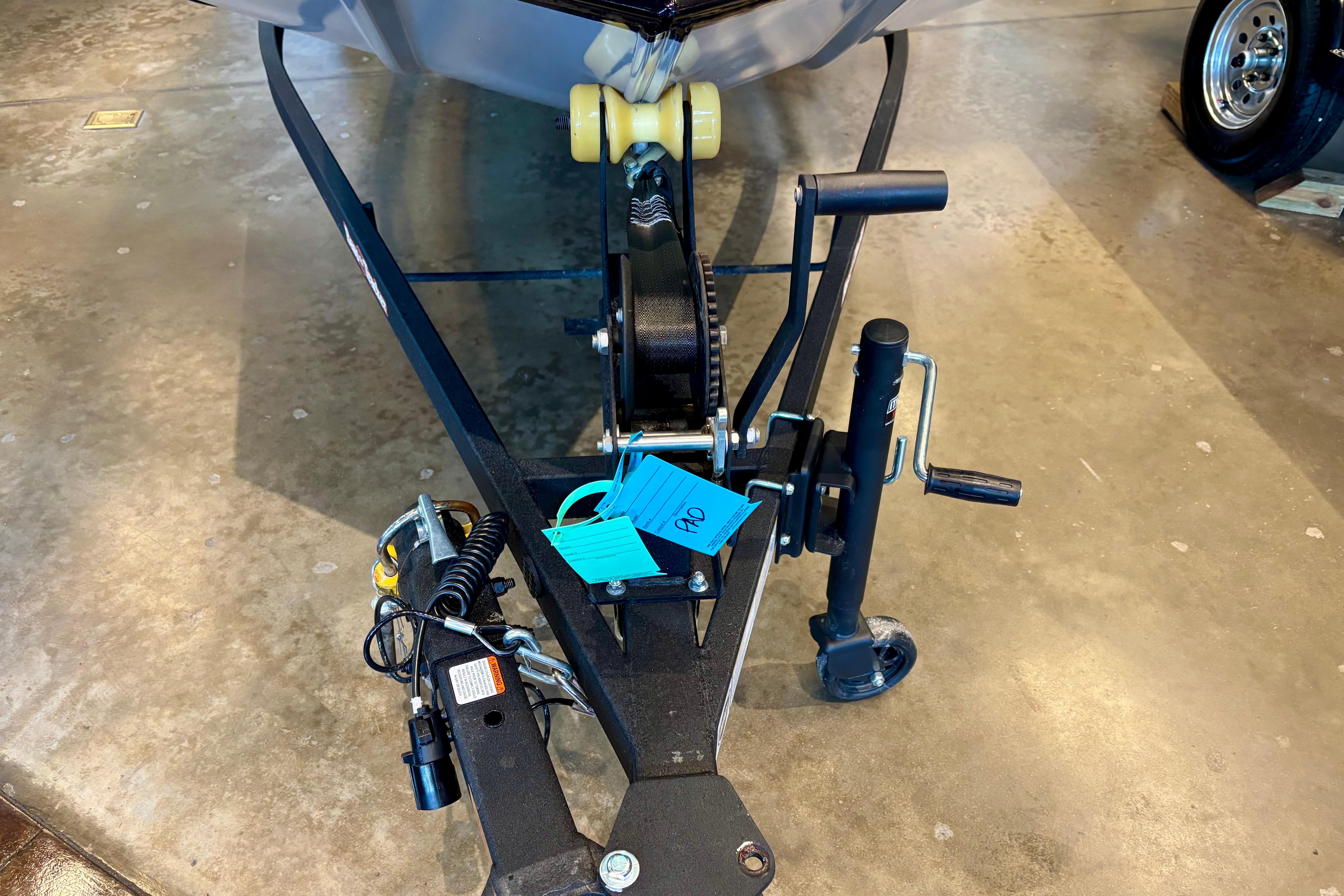 2026 Tracker Bass Tracker Classic XL trailer hitch and winch on concrete floor.