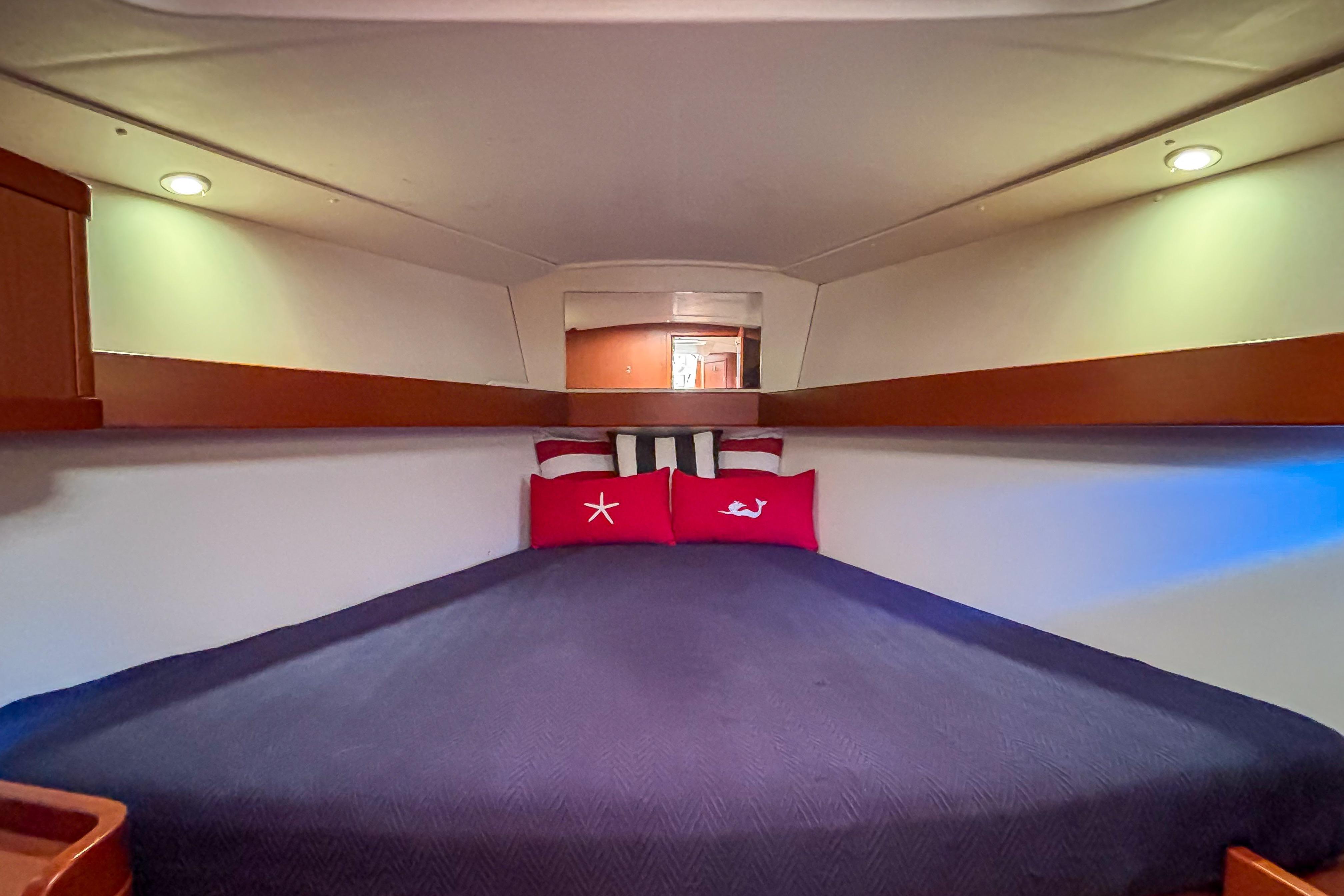 Cozy cabin interior of 2015 Beneteau Oceanis 37 sailboat with plush bedding.