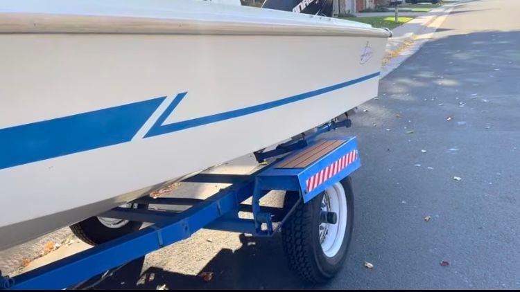 1962 Larsen 13 boat on trailer, side view.