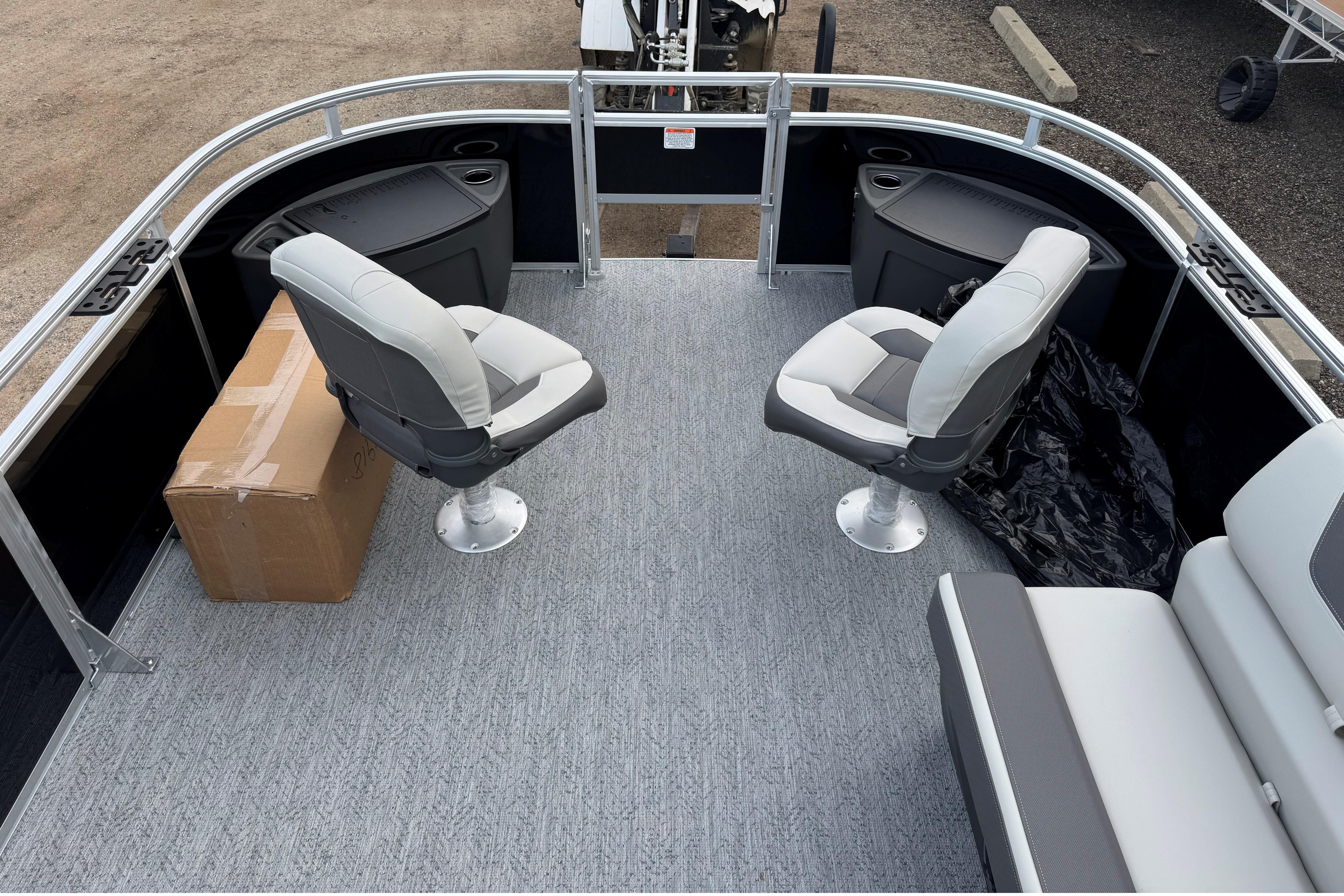 2026 Sun Tracker Fishin' Barge 22 DLX interior with seating and storage.