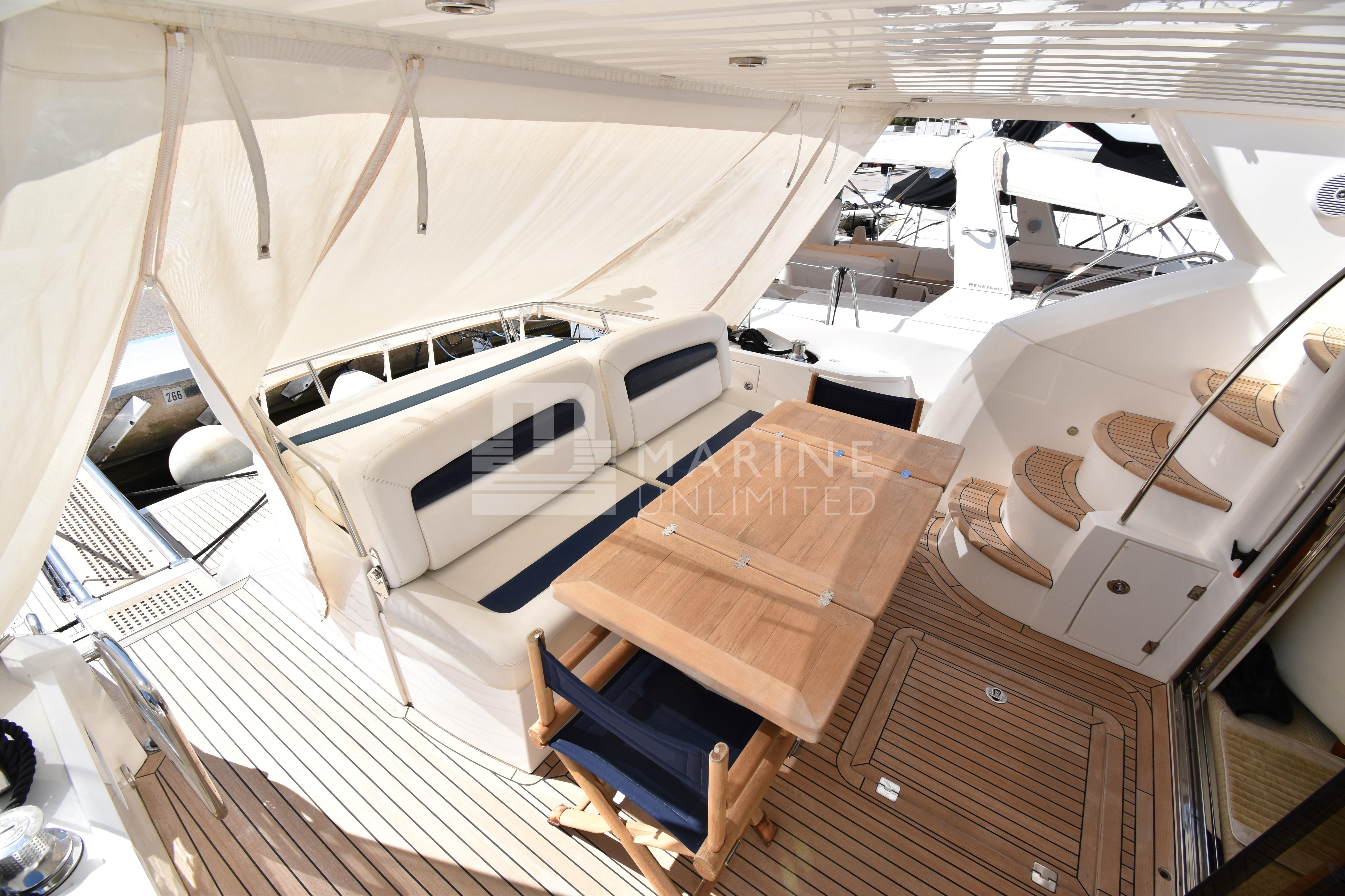 2010 Sunseeker Manhattan 52 yacht deck with seating and wooden table.