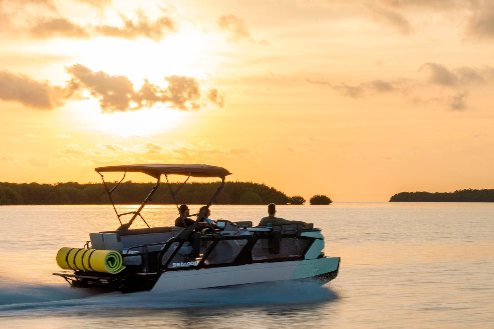 2026 Sea-Doo Switch Cruise 21 on water at sunset, showcasing sleek design and performance.