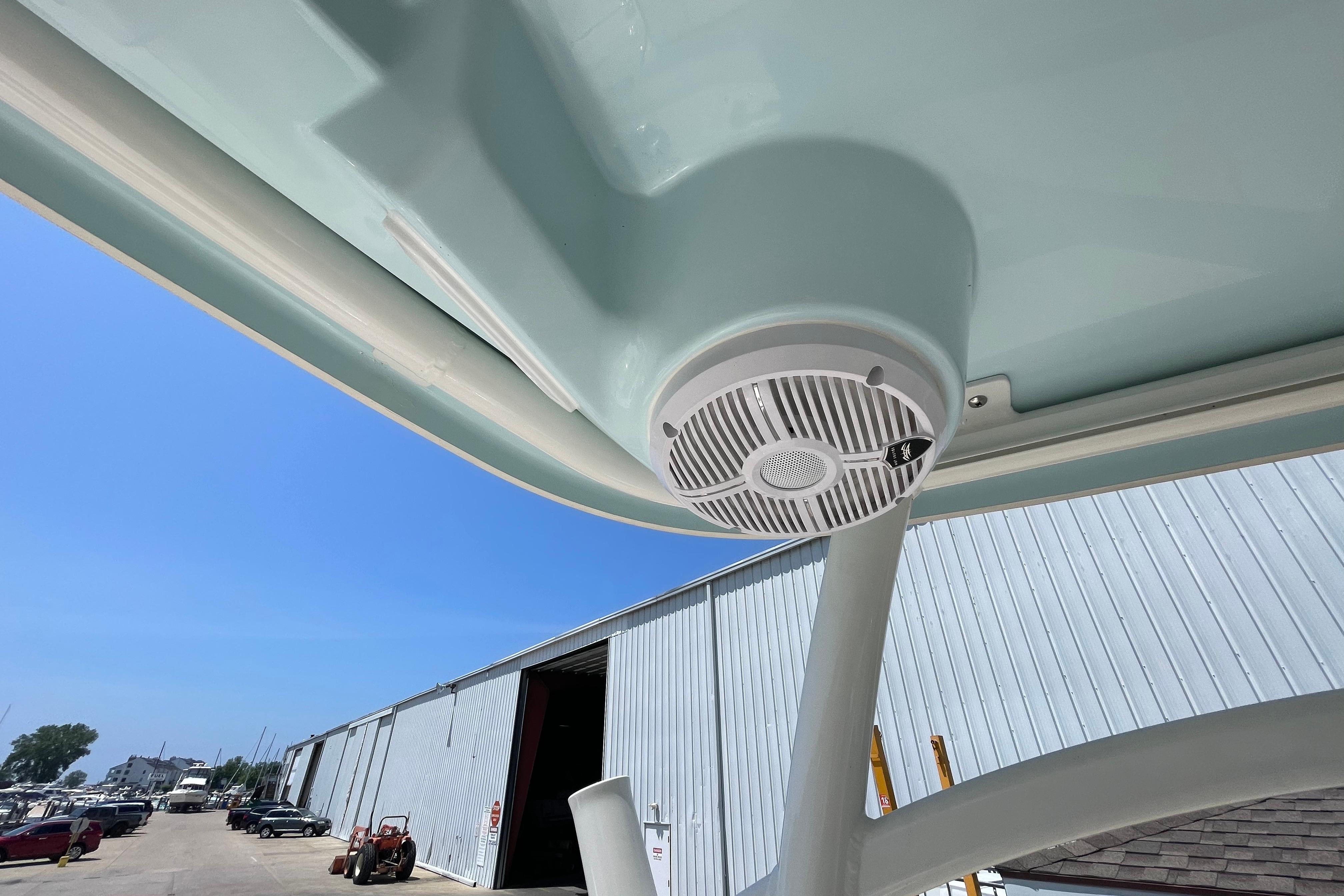 2022 Sailfish 245 DC boat speaker under canopy, dockside view.