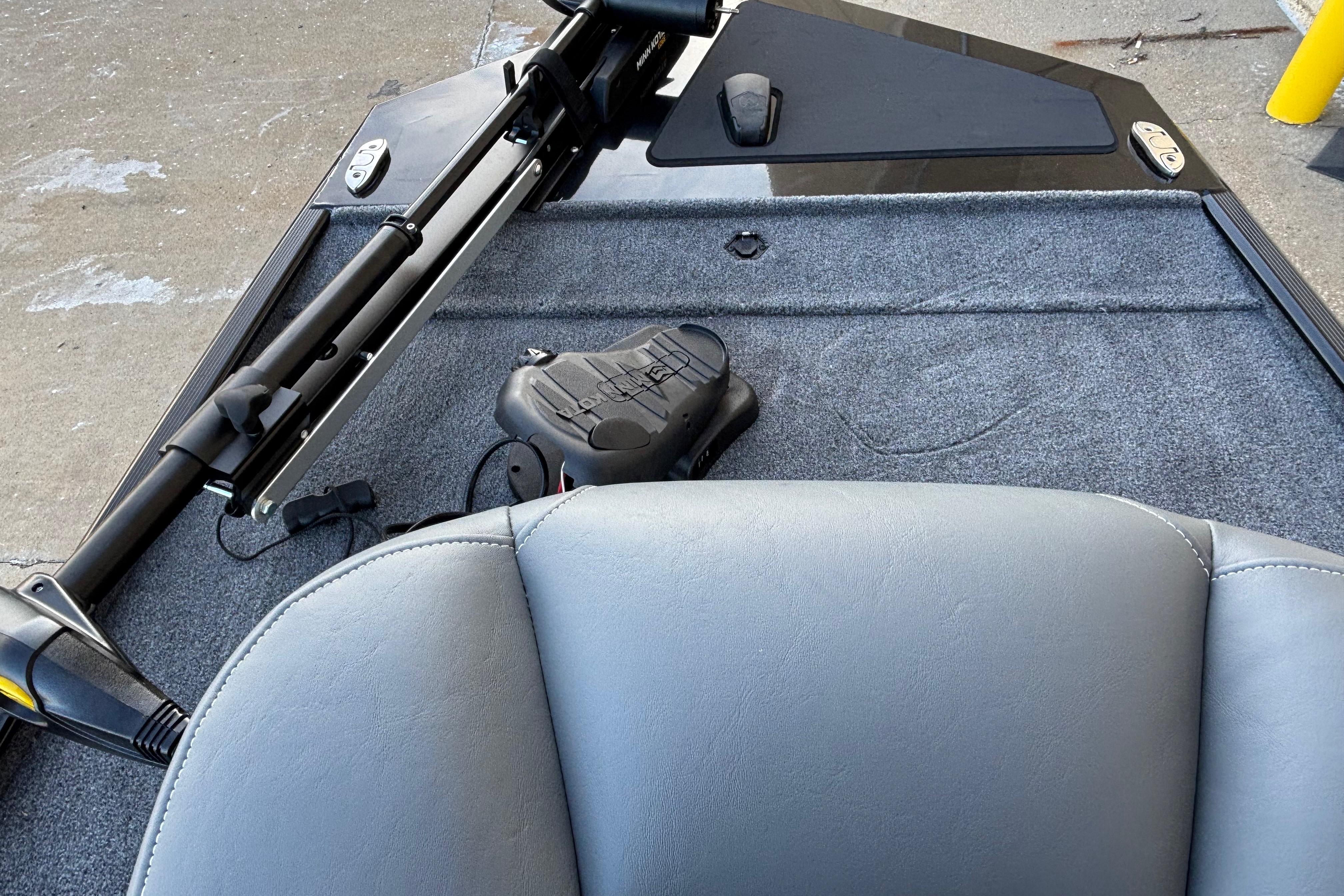 2026 Tracker Bass Tracker Classic XL boat interior with gray seating and fishing equipment.