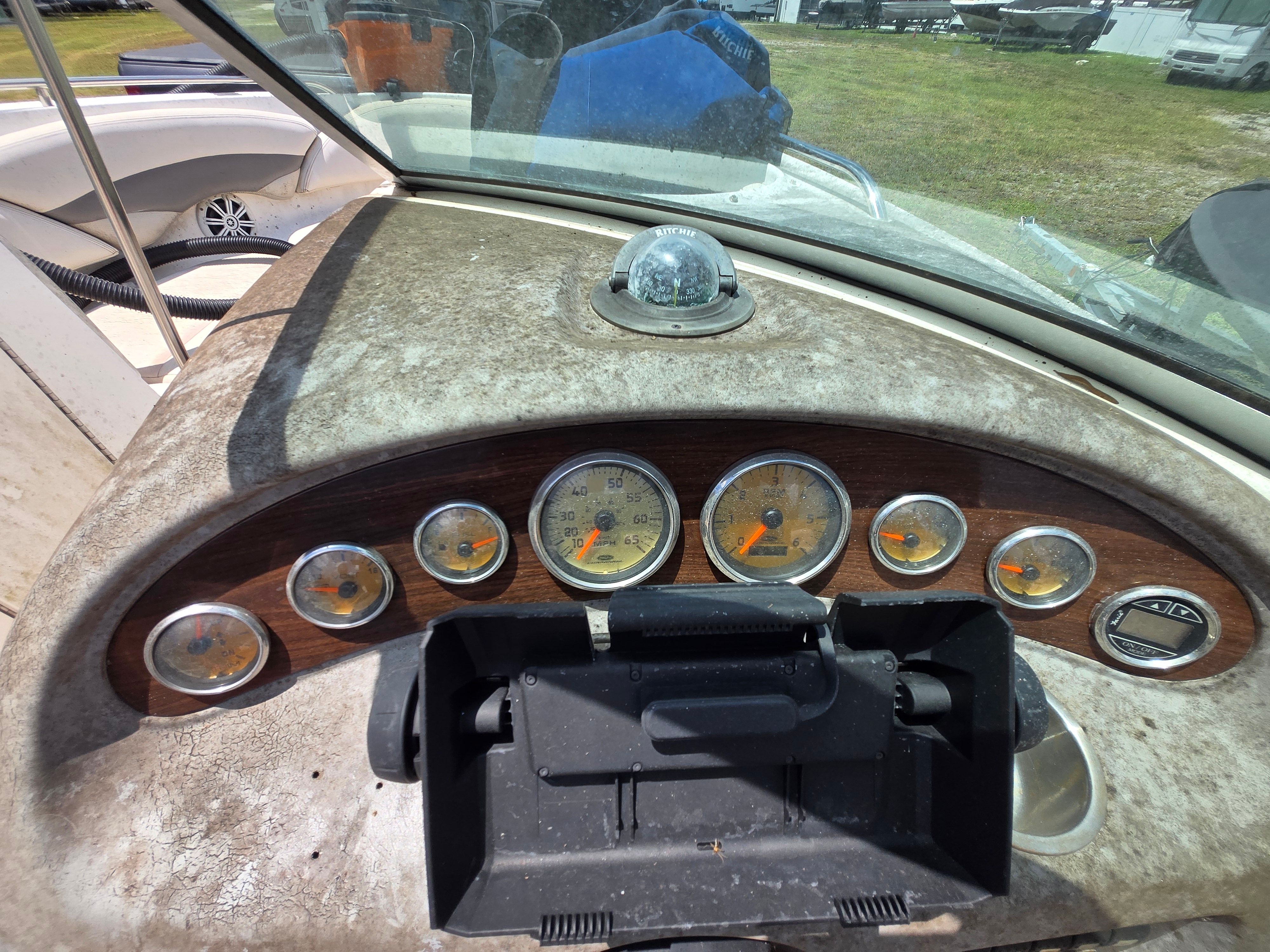 The dashboard of a 2006 Chaparral 220 SSi with multiple gauges and a compass.