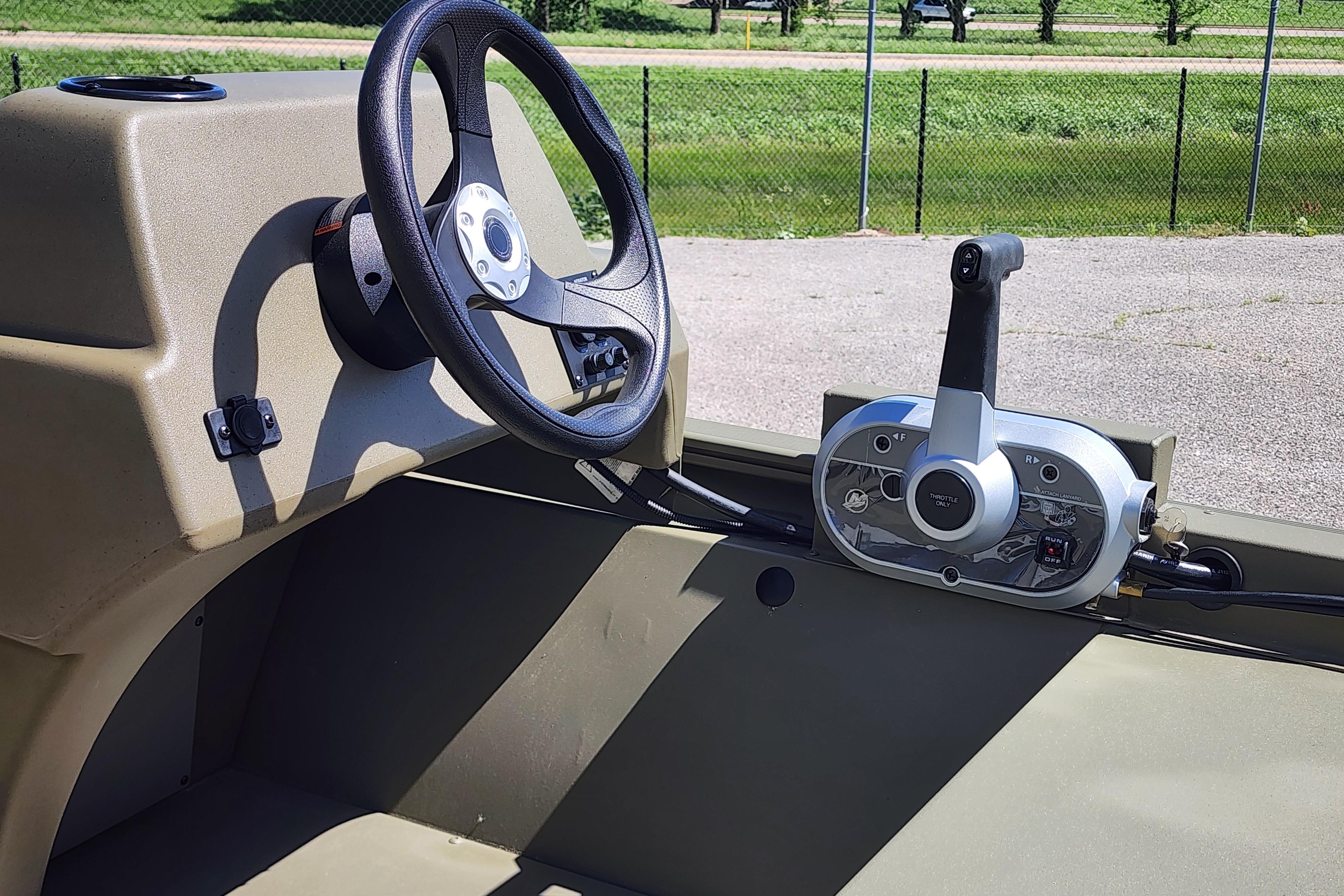 Steering console of 2026 Tracker Grizzly 1648 SC boat, featuring modern controls.