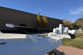 2025 Ranger 2510 Bay boat with trolling motor, parked outdoors on a sunny day.