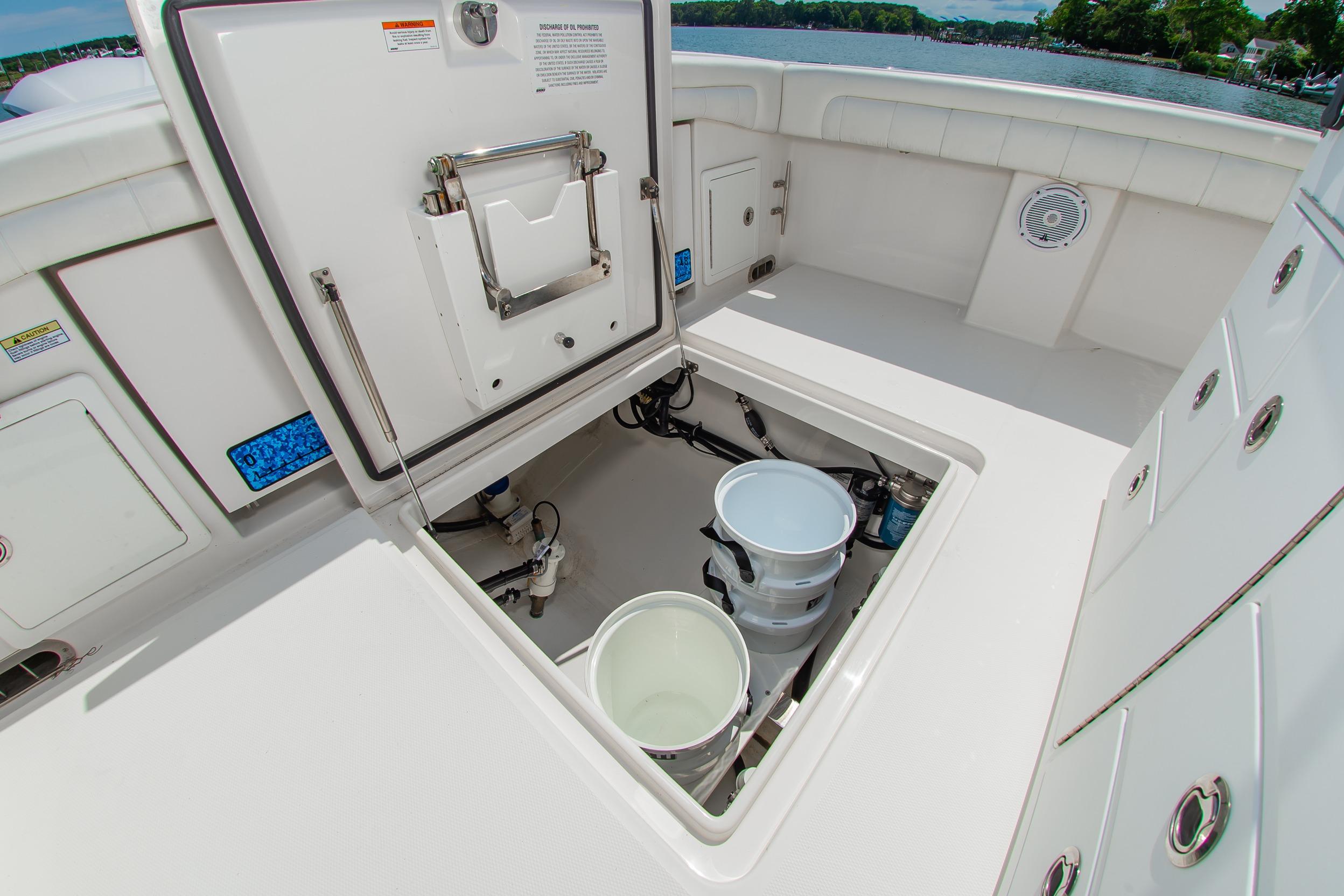 2019 Regulator 31 boat storage compartment with open hatch and buckets.