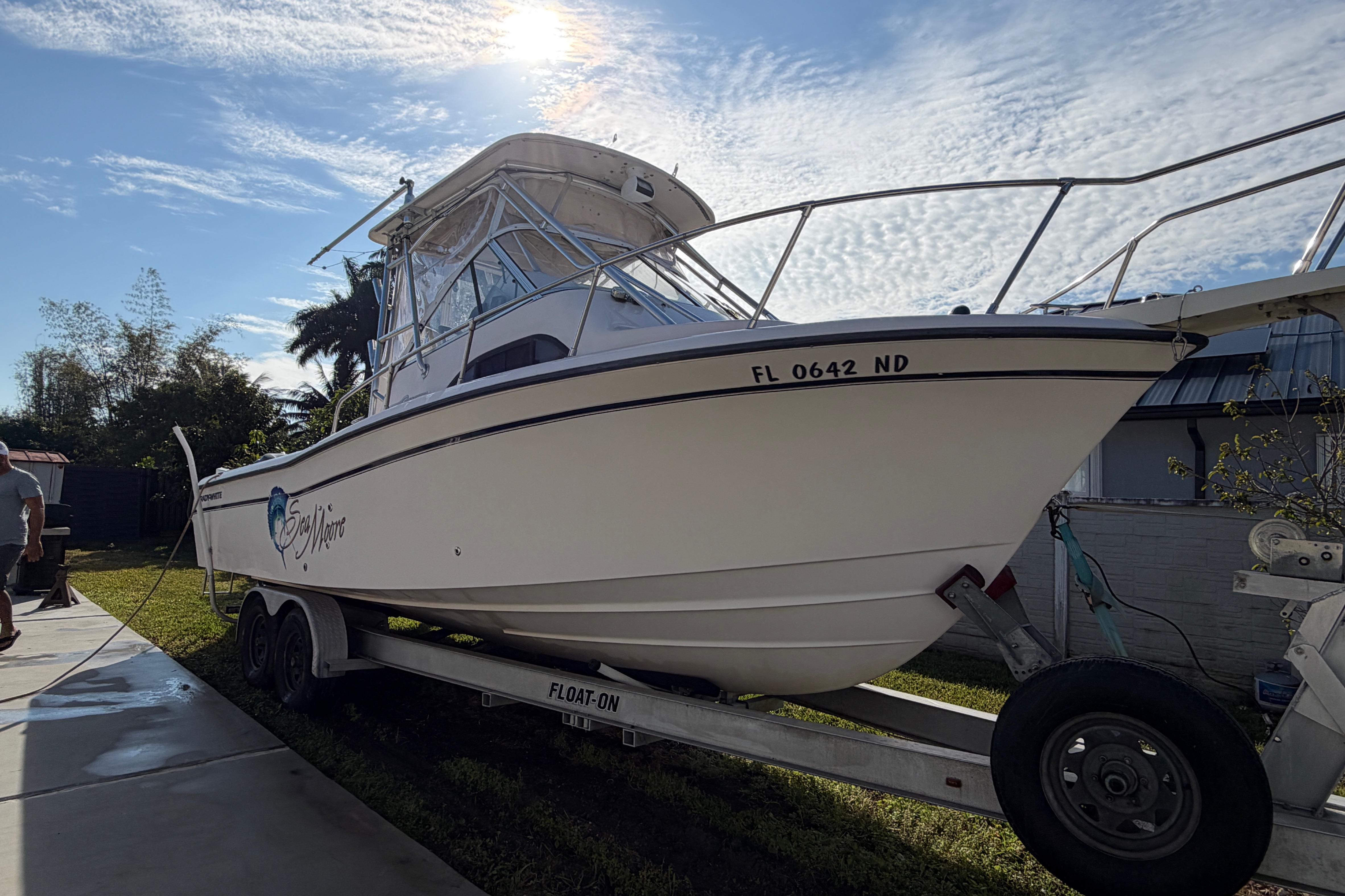 2006 Grady-White Sailfish 282 boat on trailer under sunny sky.