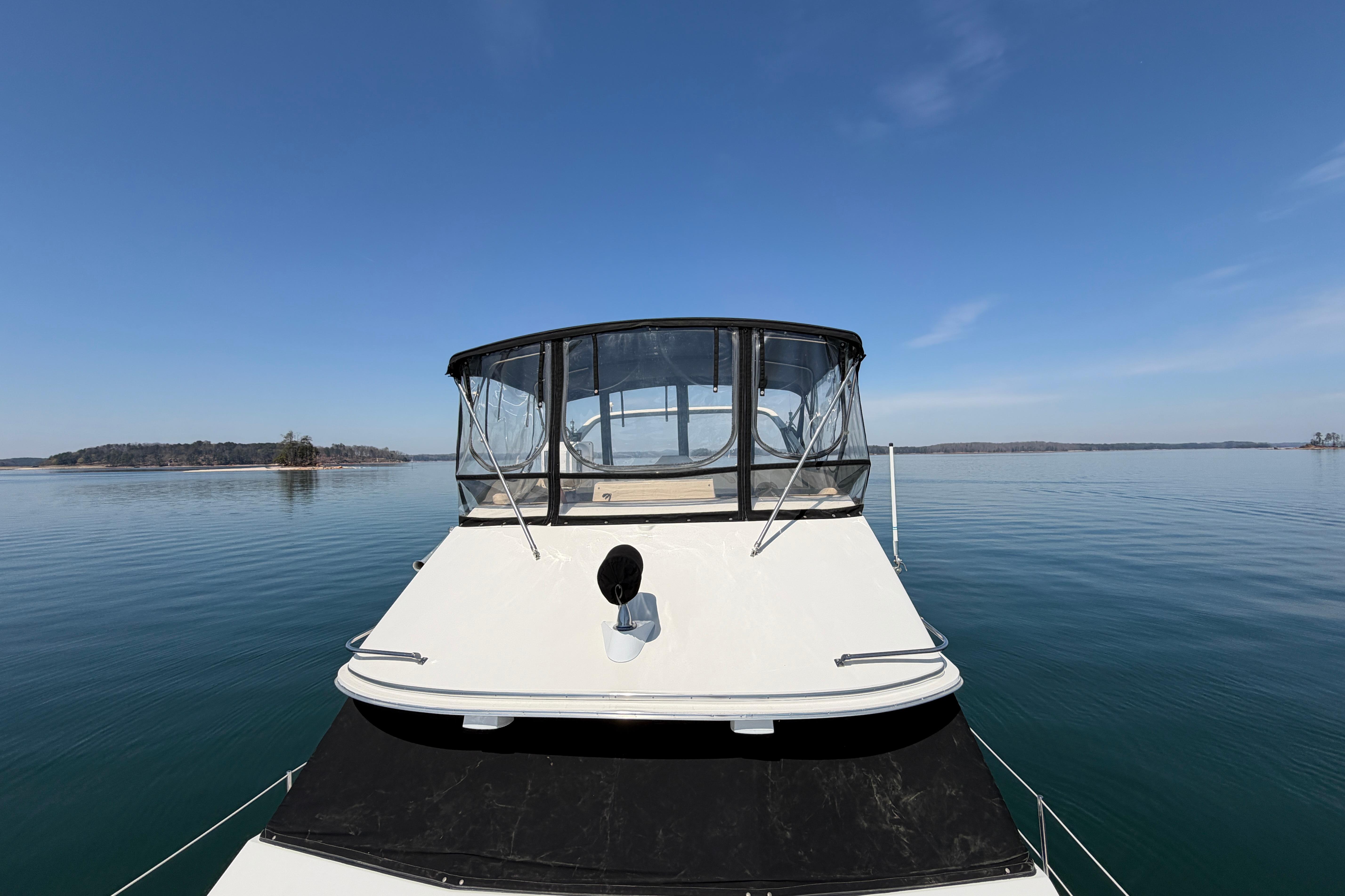 1994 Bayliner 3888 MY Sedan on calm water under clear blue sky.