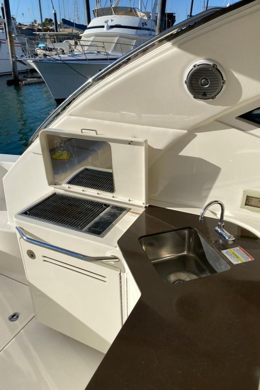 2012 Sea Ray 470 Sundancer yacht with outdoor kitchenette and sink.