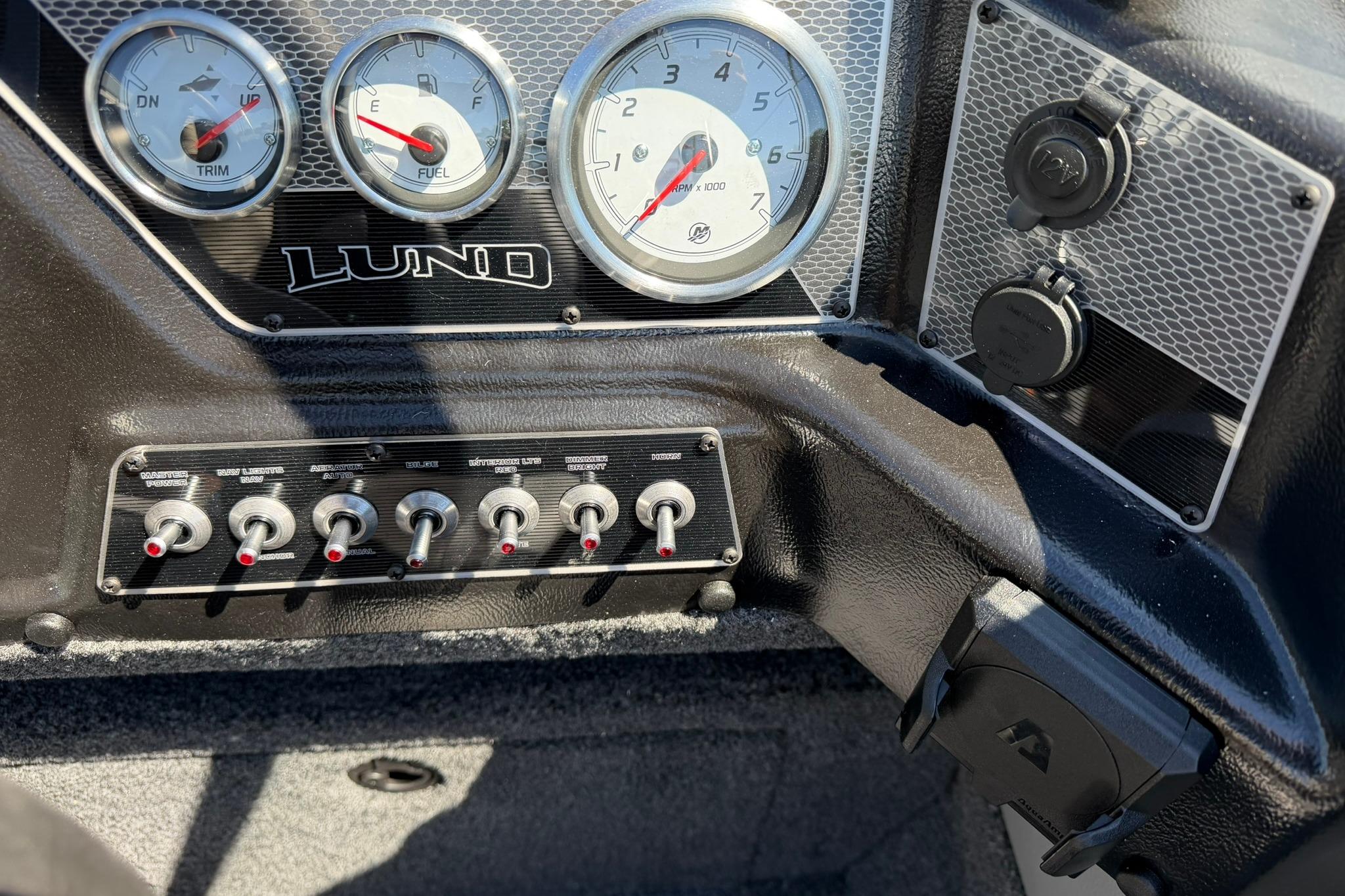 Dashboard of 2027 Lund 1775 Crossover XS boat with gauges and switches.