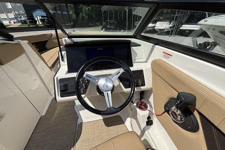 2019 Sea Ray SPX 230 Outboard boat interior with steering wheel and control panel.