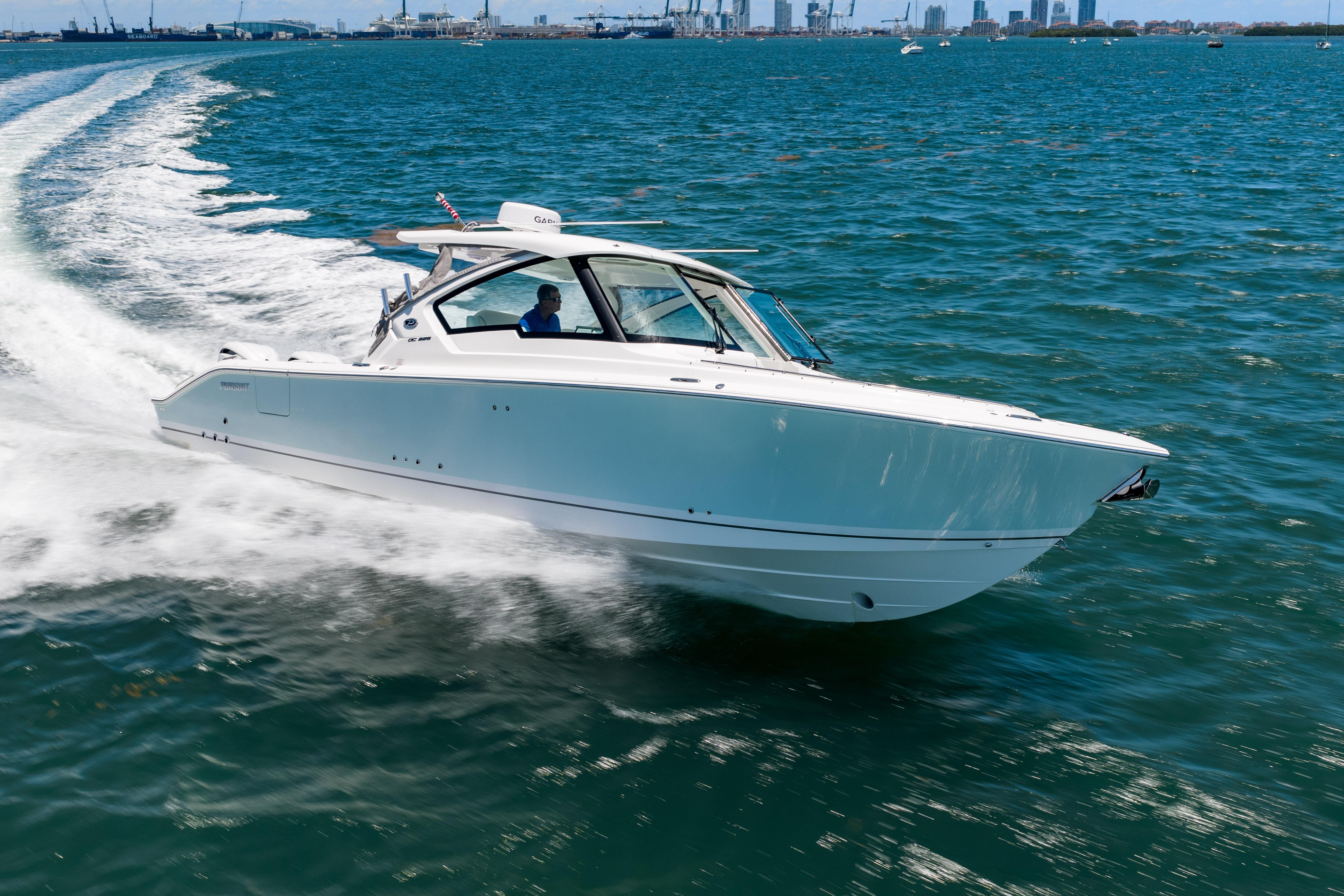 2026 Pursuit DC 326 Dual Console cruising on open water, showcasing sleek design and performance.