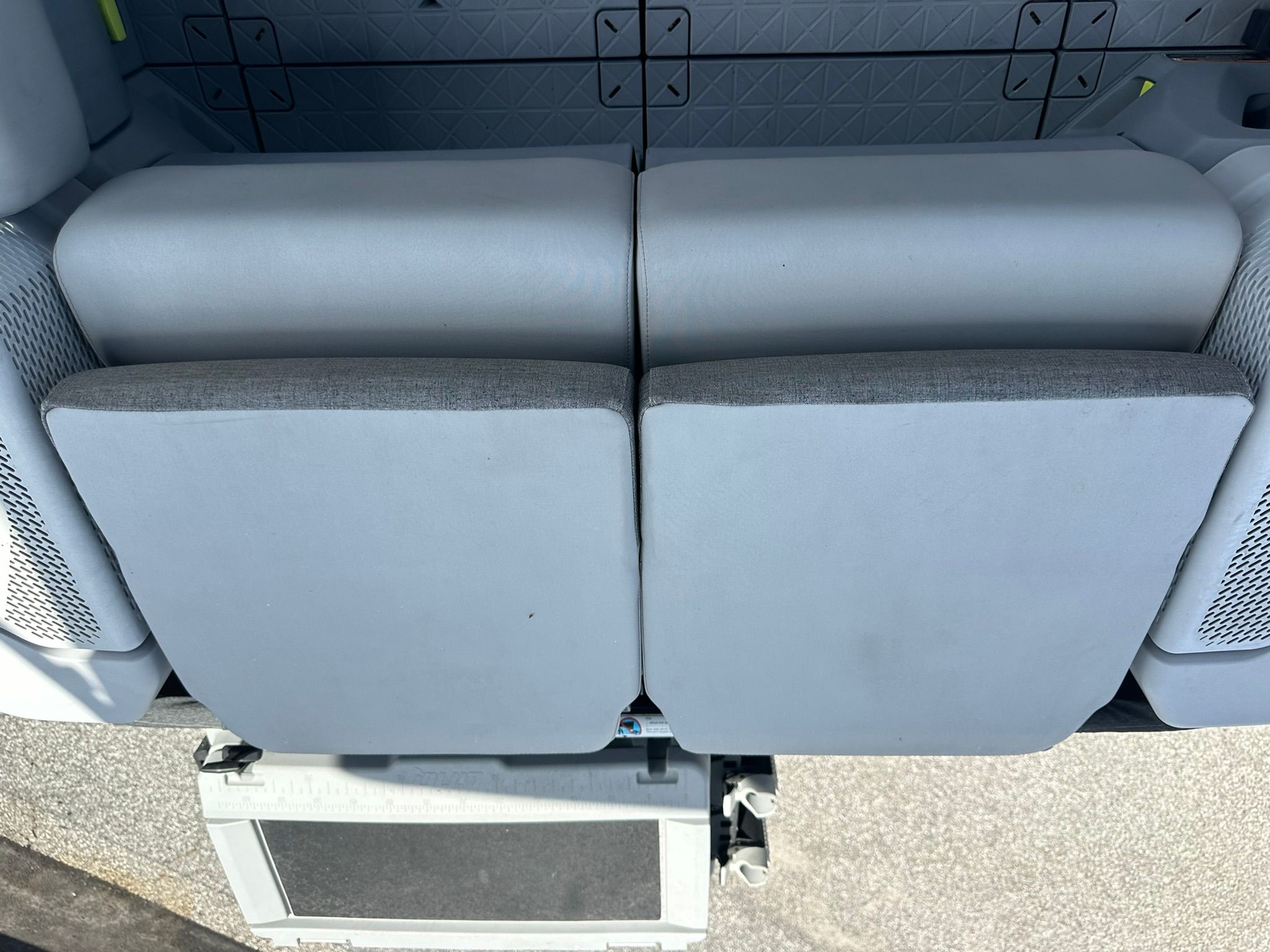 Rear view of two gray boat seats with mesh pockets on the sides.