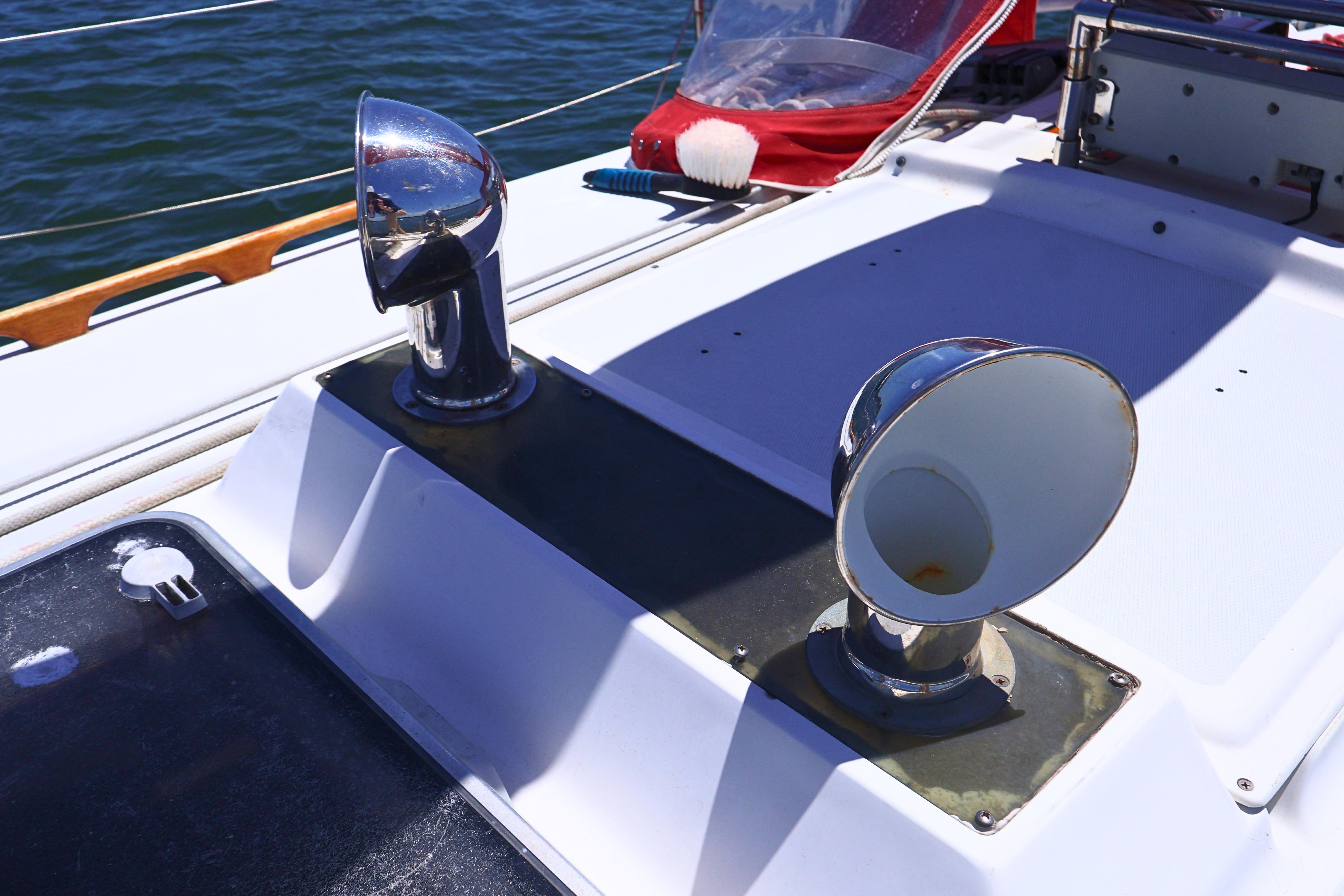 1989 J Boat J 40 deck with chrome vents and ocean backdrop.