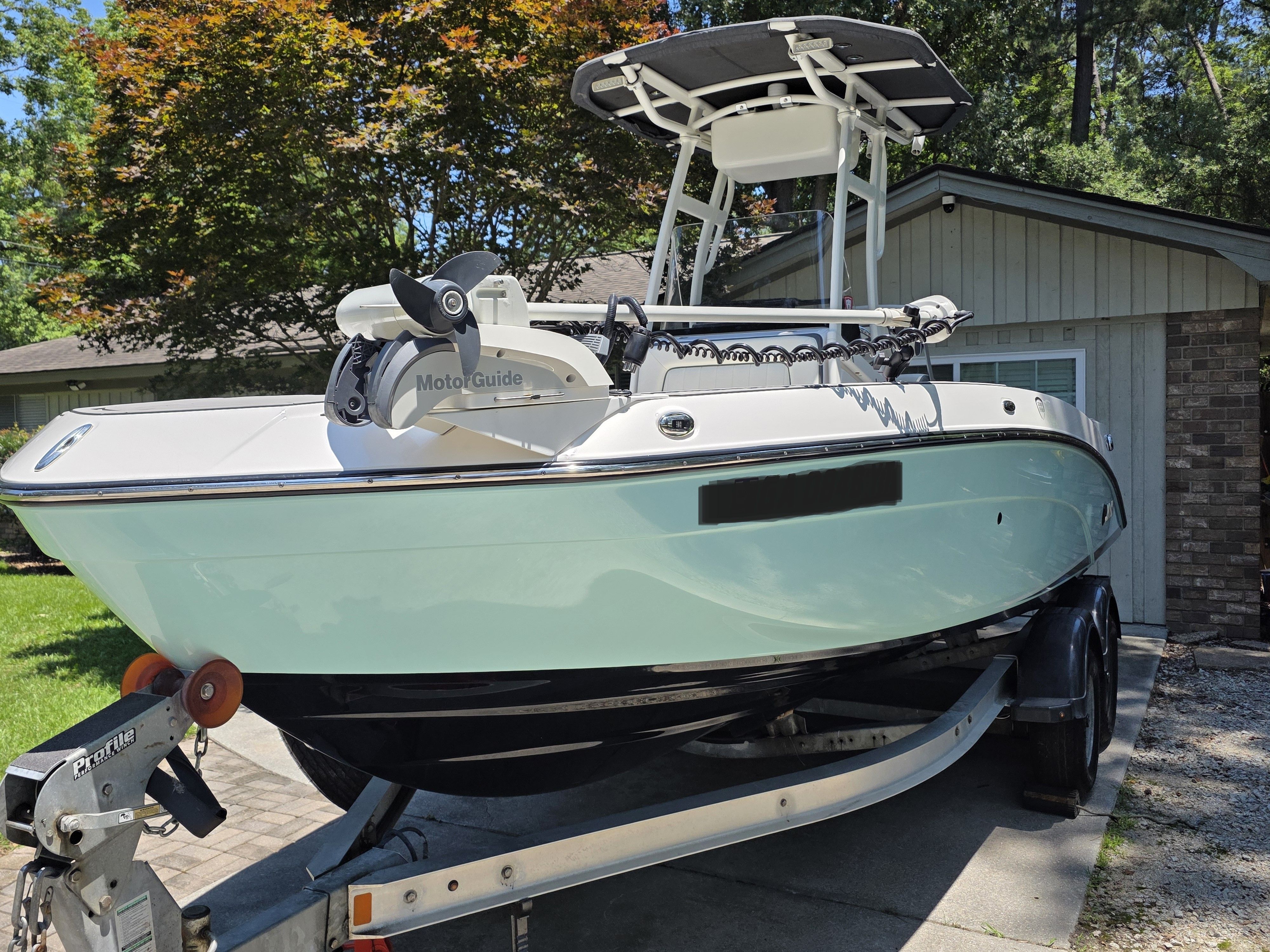 Yamaha 210 FSH Sport 2020 on trailer in front of garage.