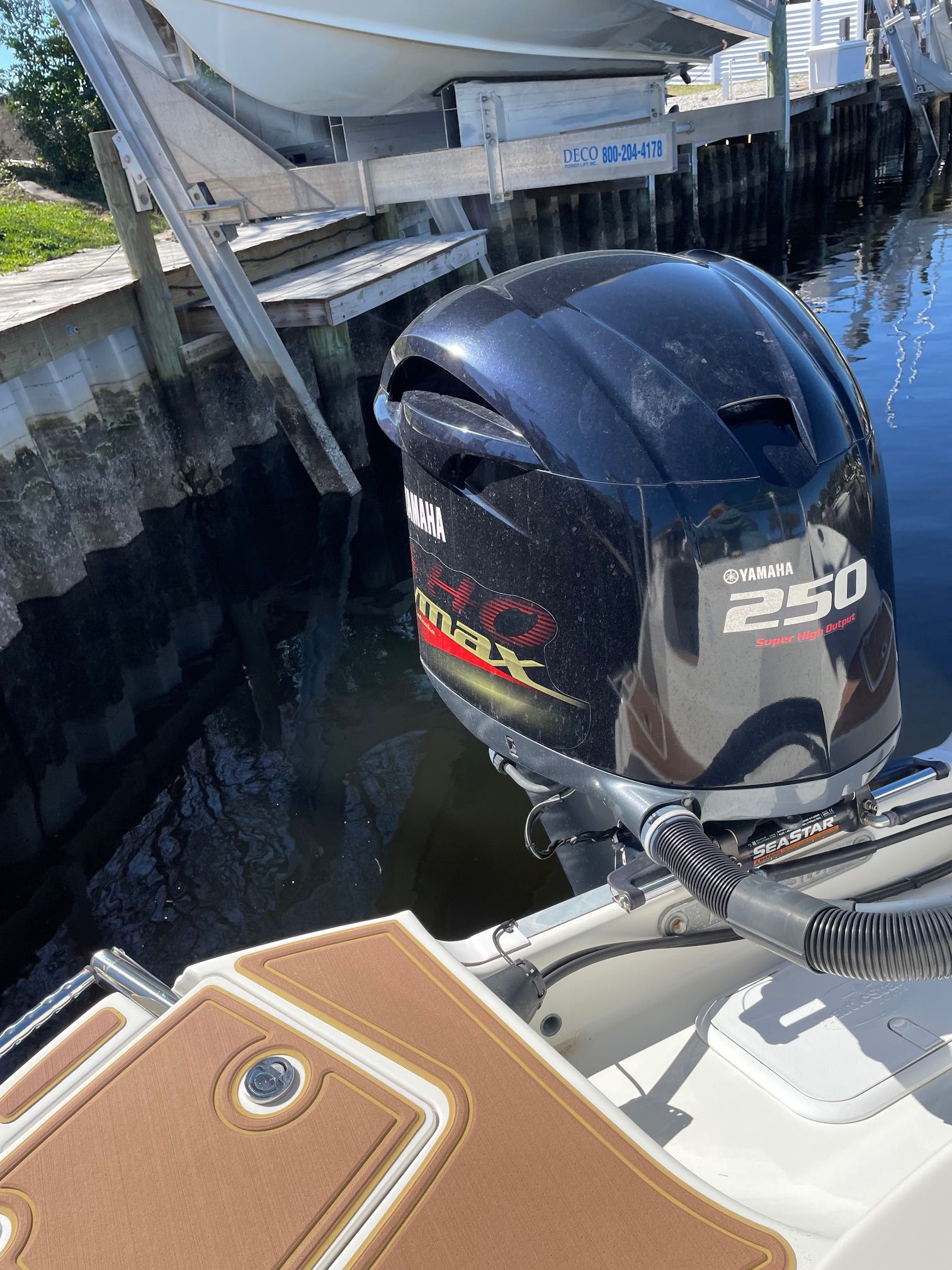 A Yamaha 250 horsepower outboard motor on a boat docked at a pier.
