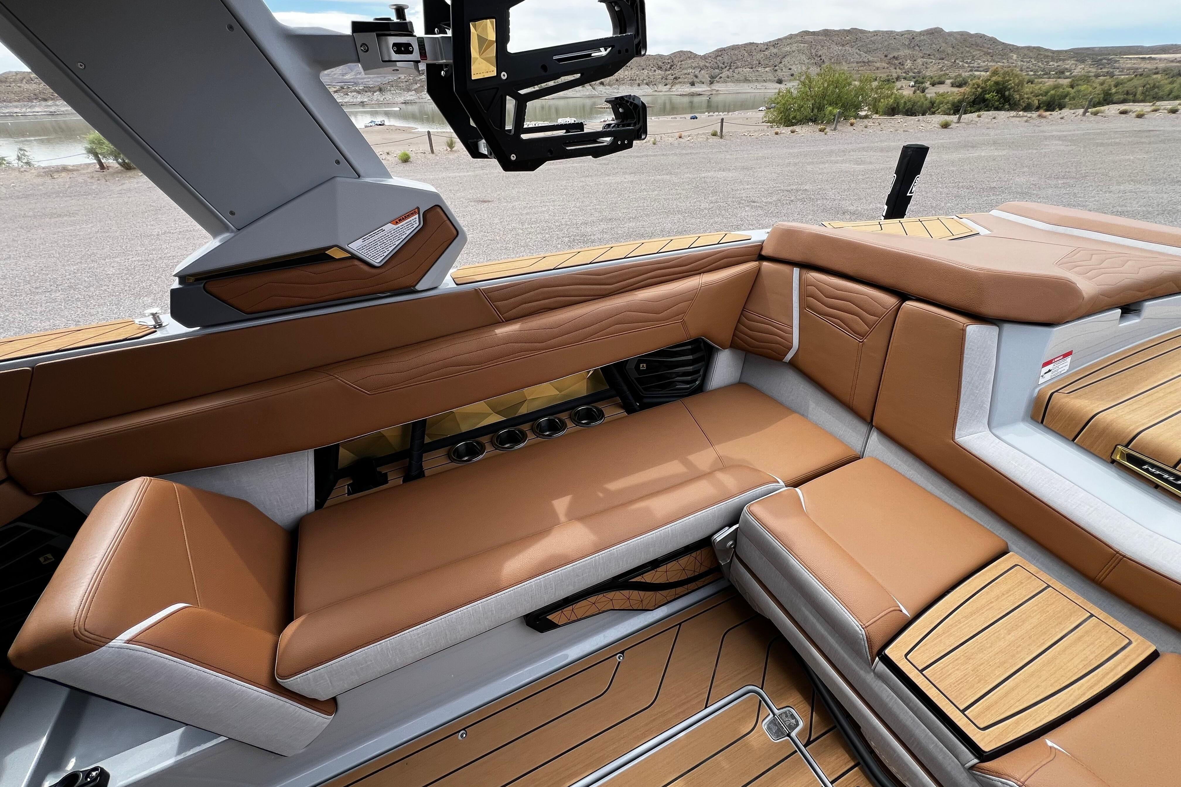 Luxurious interior of 2026 Nautique Super Air Nautique G25 boat with tan seating.