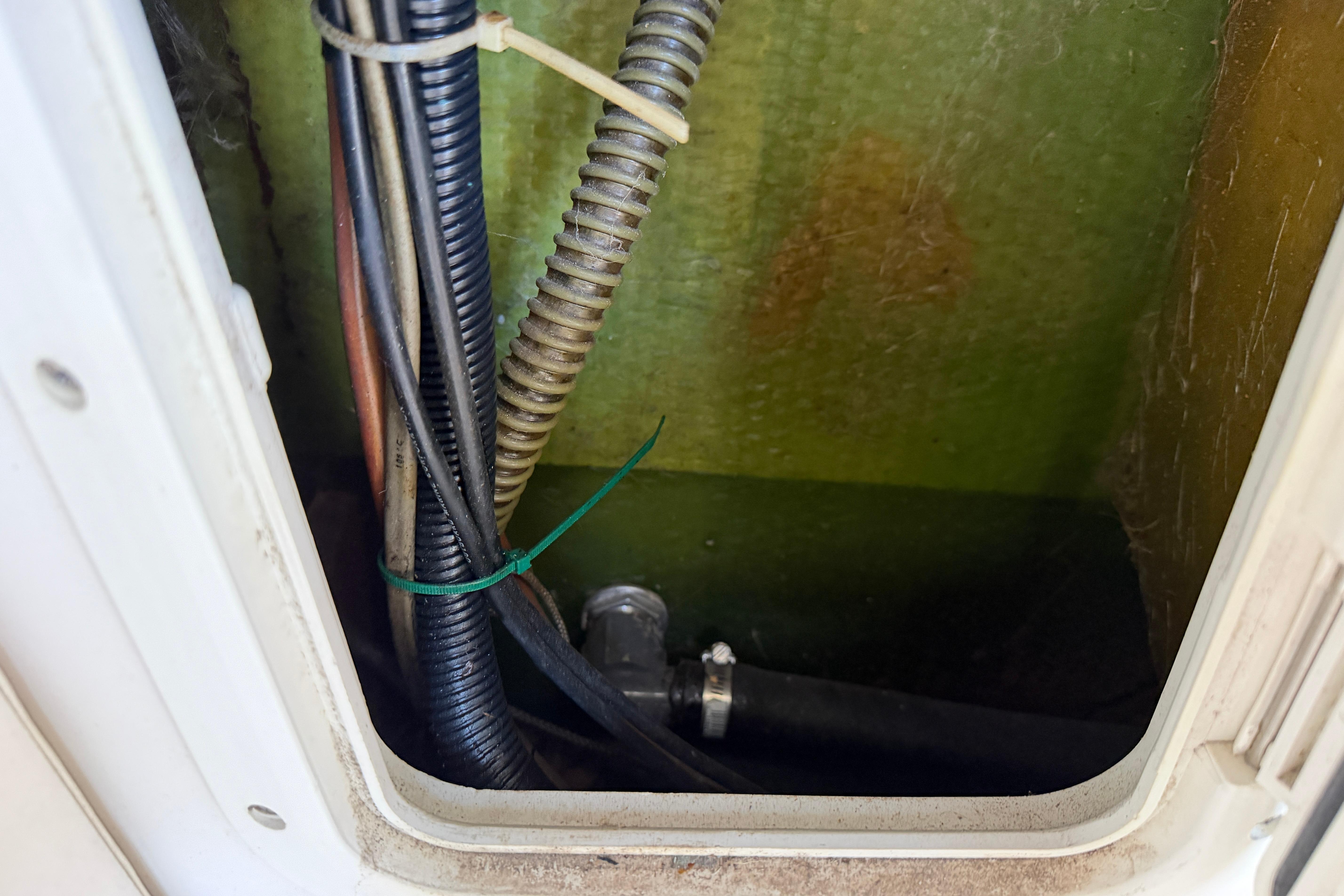 1987 Grady-White Seafarer 226 wiring and tubing inside compartment.