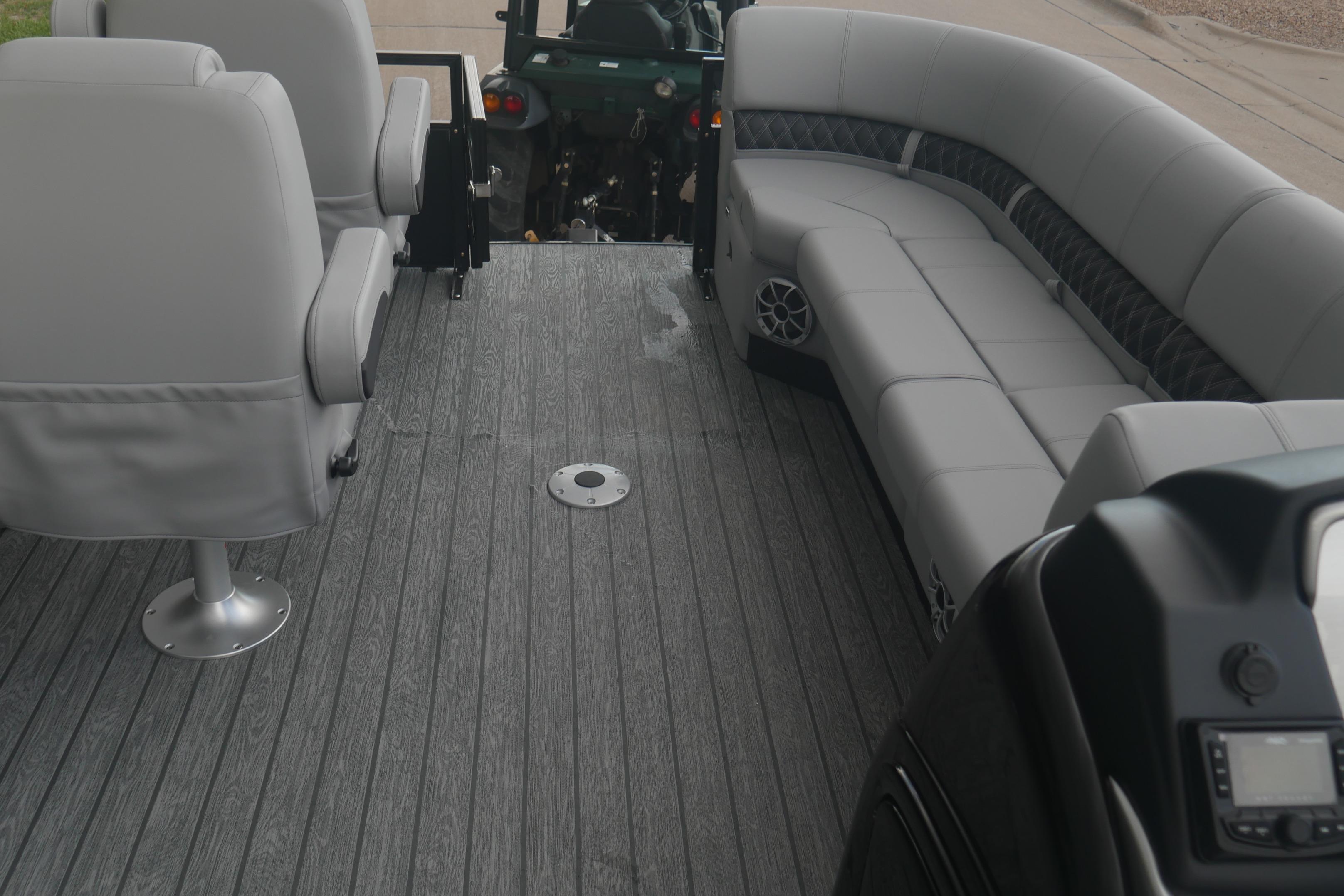 2026 Ranger 220FC boat interior with gray seating and wood-textured flooring.