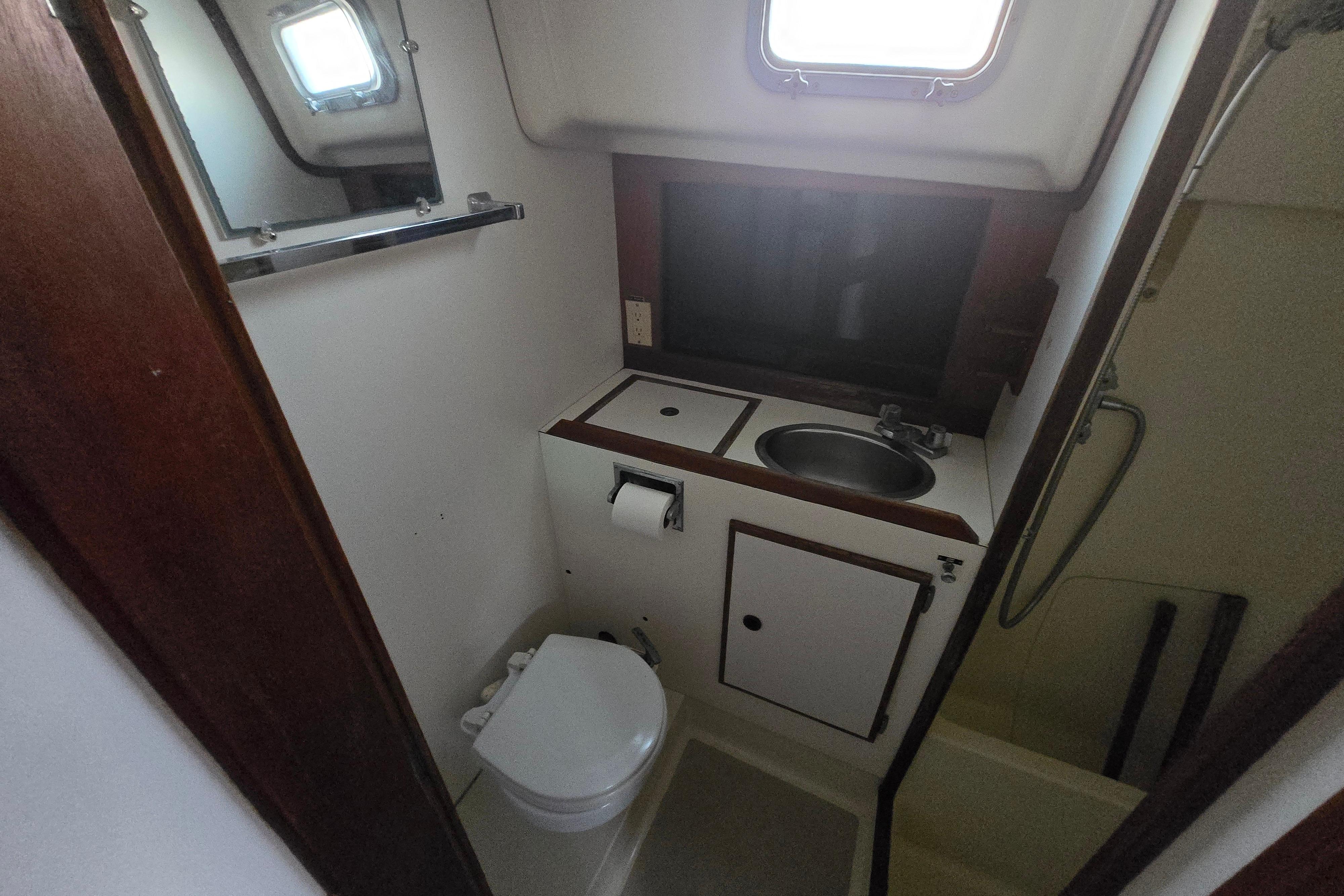 1980 Pearson 365 Sloop bathroom with sink, toilet, and shower area.