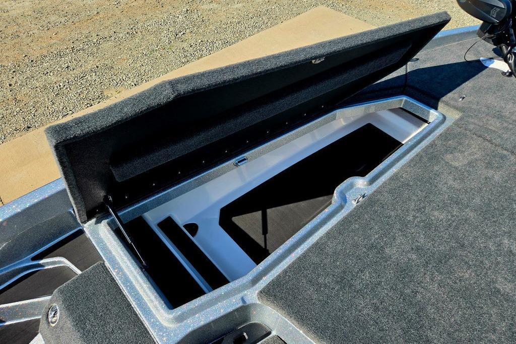 Open storage compartment on 2026 Skeeter ZXE20 boat, showcasing spacious interior design.