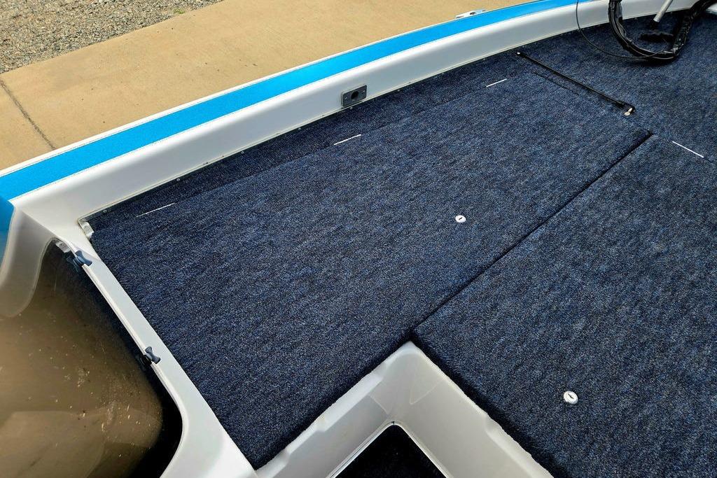 1996 Champion 181 SX boat deck with blue carpet and storage compartments.